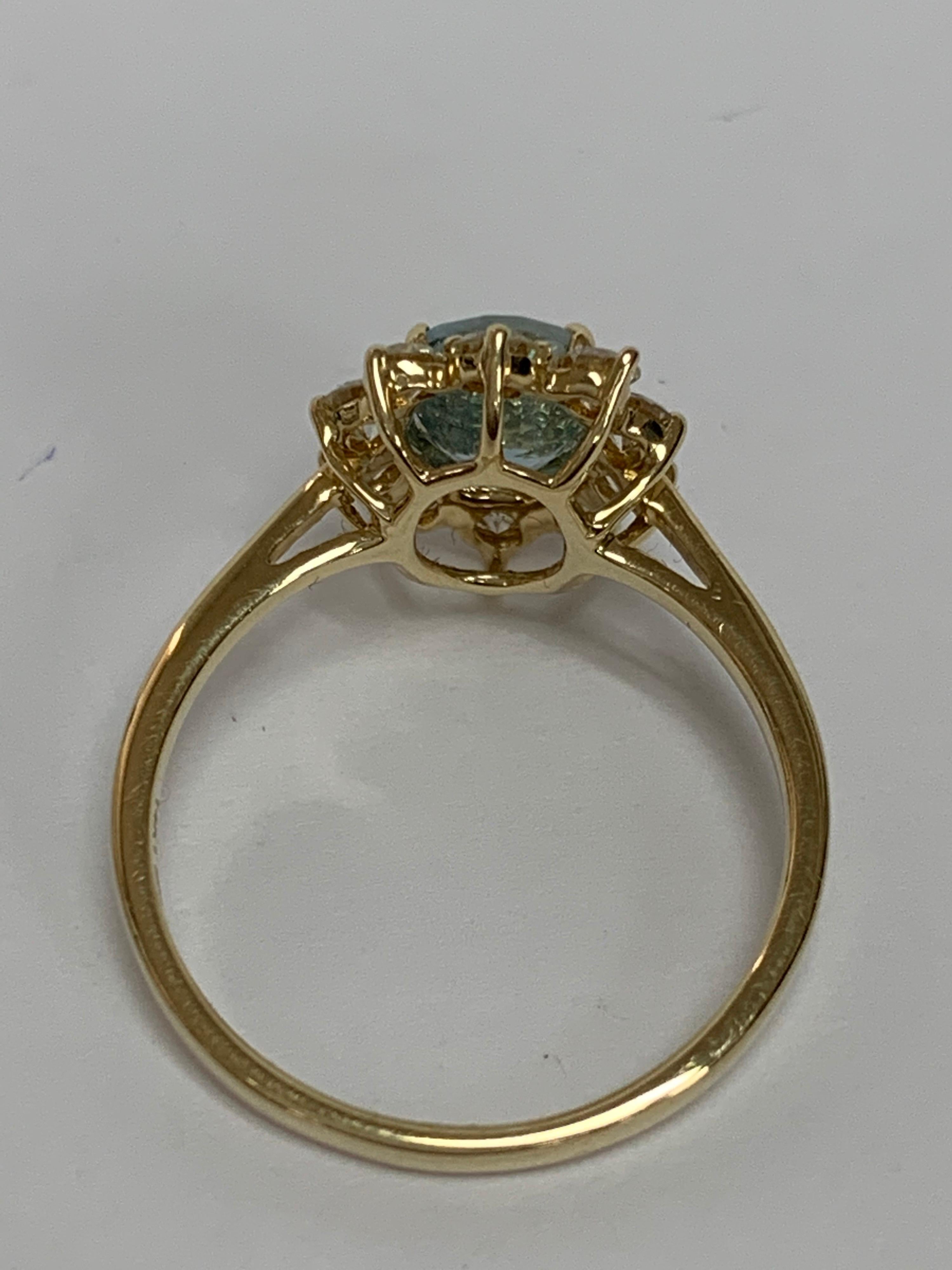 Oval Cut Oval Aquamarine and White Round Diamond Ring Set in 14 Karat Yellow Gold