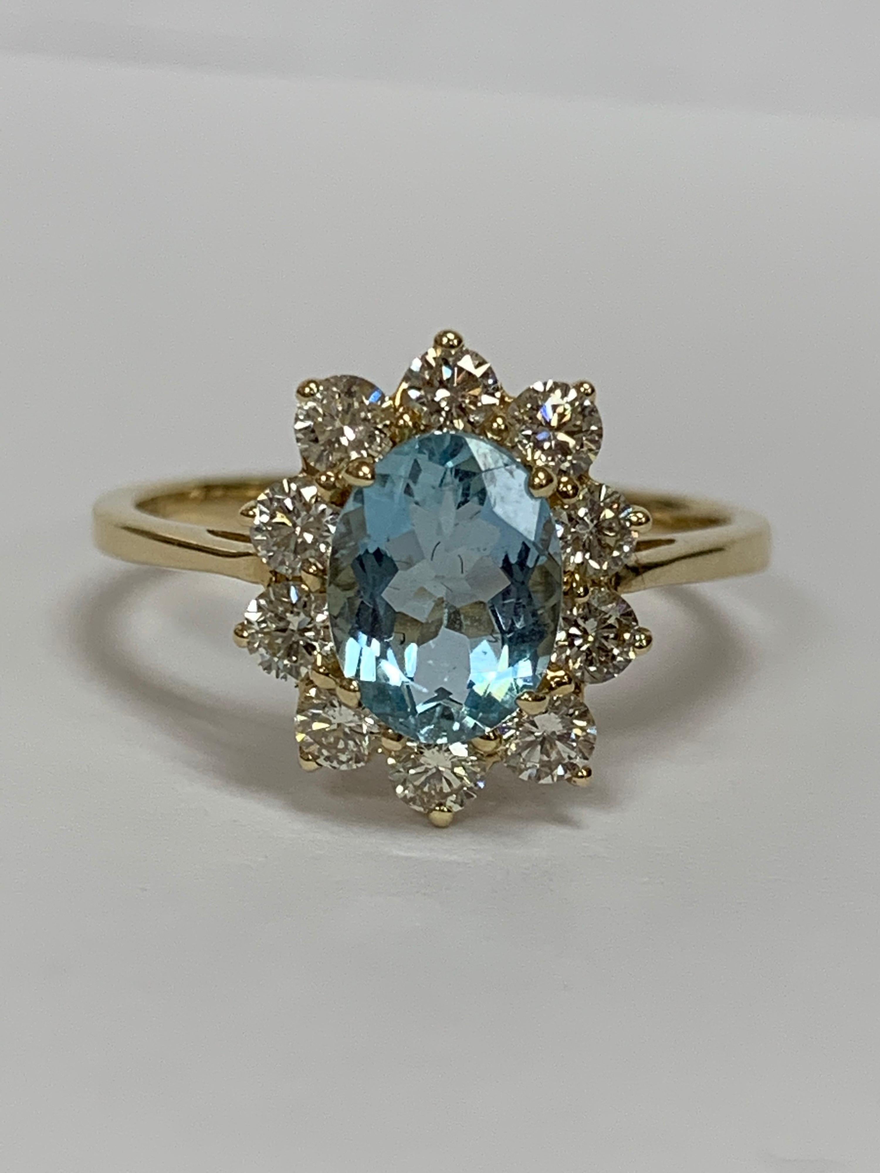 Oval Aquamarine and White Round Diamond Ring Set in 14 Karat Yellow Gold In New Condition In Trumbull, CT