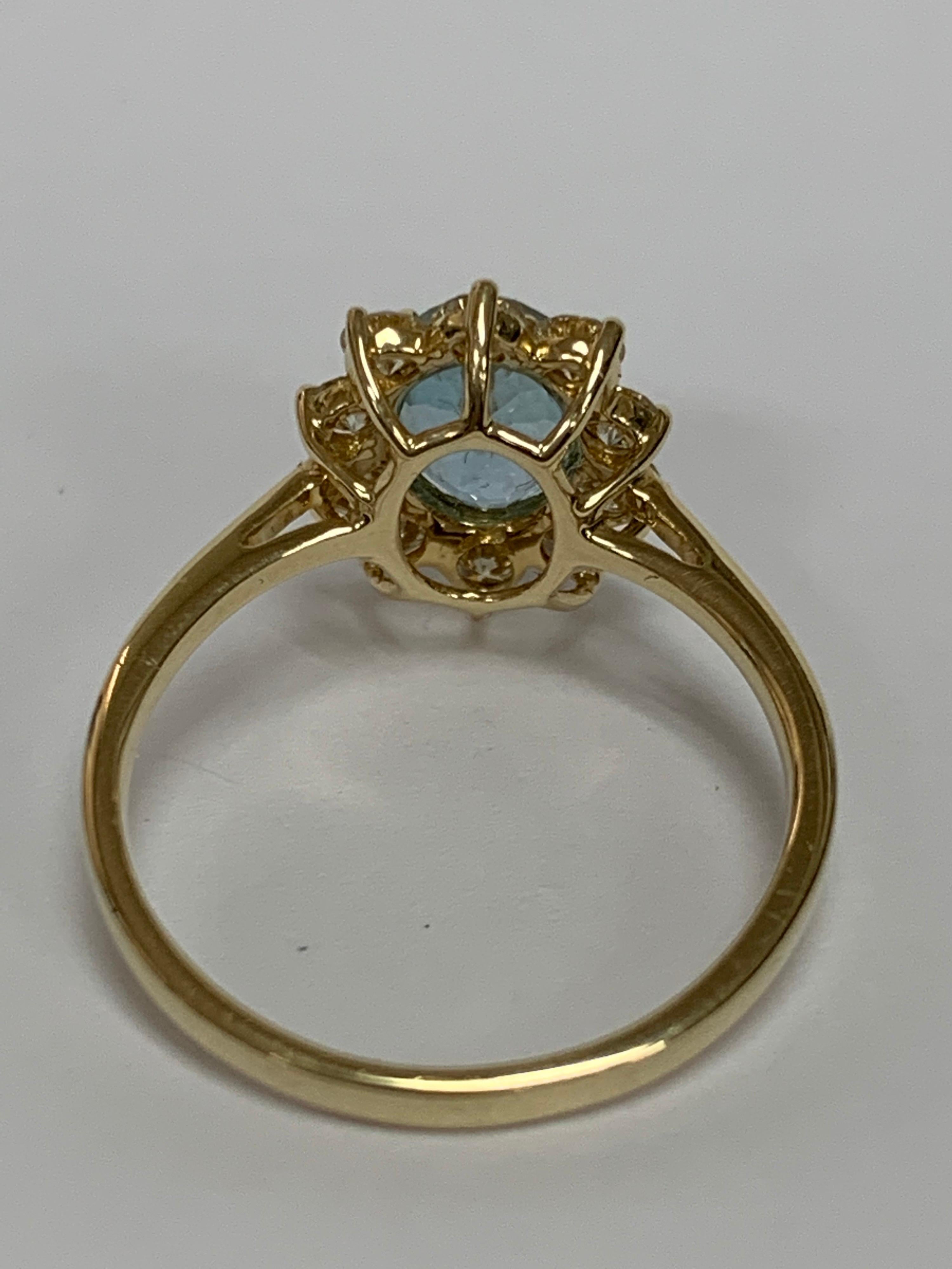 Women's Oval Aquamarine and White Round Diamond Ring Set in 14 Karat Yellow Gold