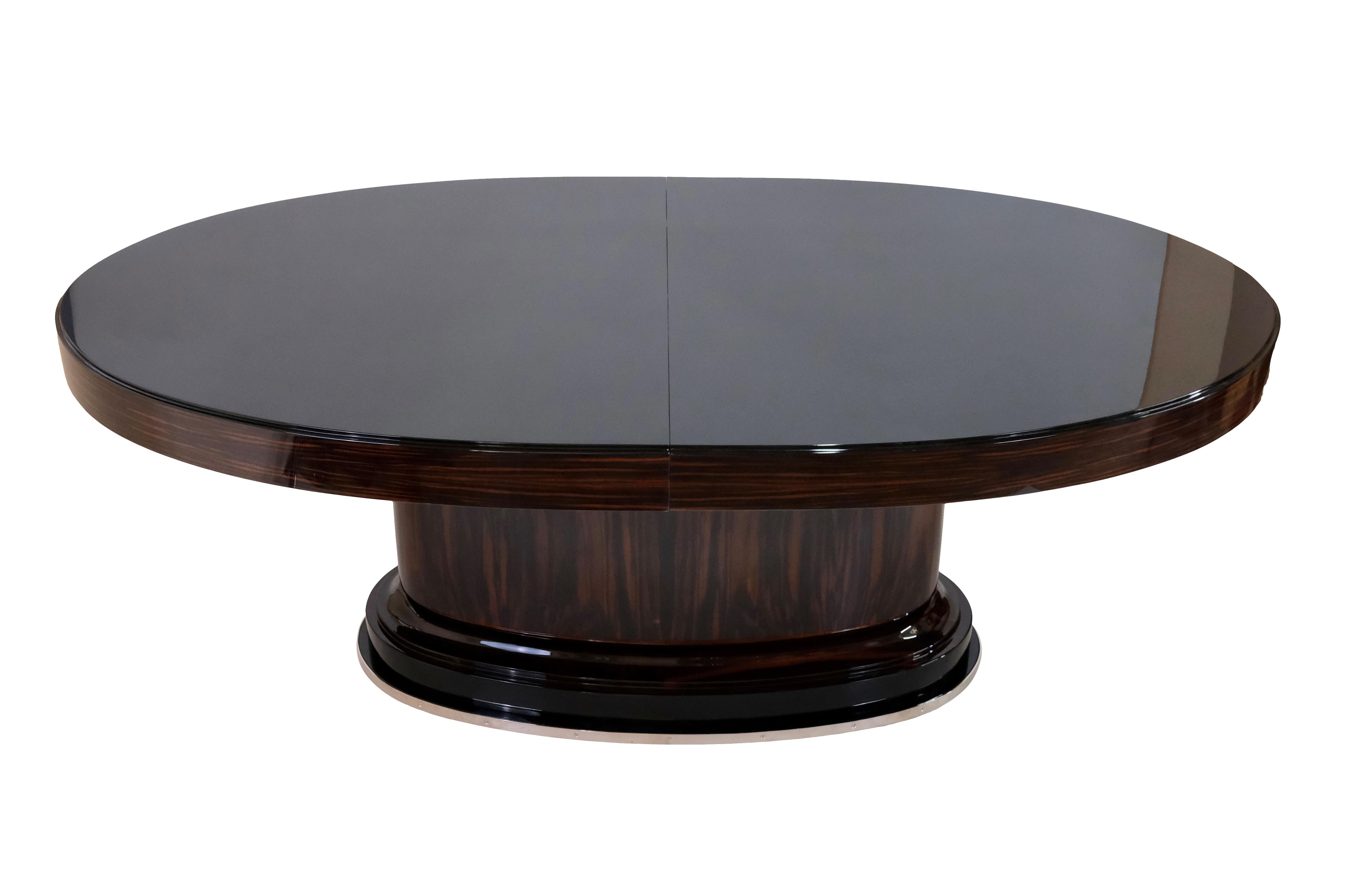 Large oval dining table with extension 
Macassar Veneer, high gloss lacquered 
One stable foot in the middle 
Base with nickeled Metal 
Tabletop in black piano lacquer, high gloss
The upper surface can be protected with a glass plate black in