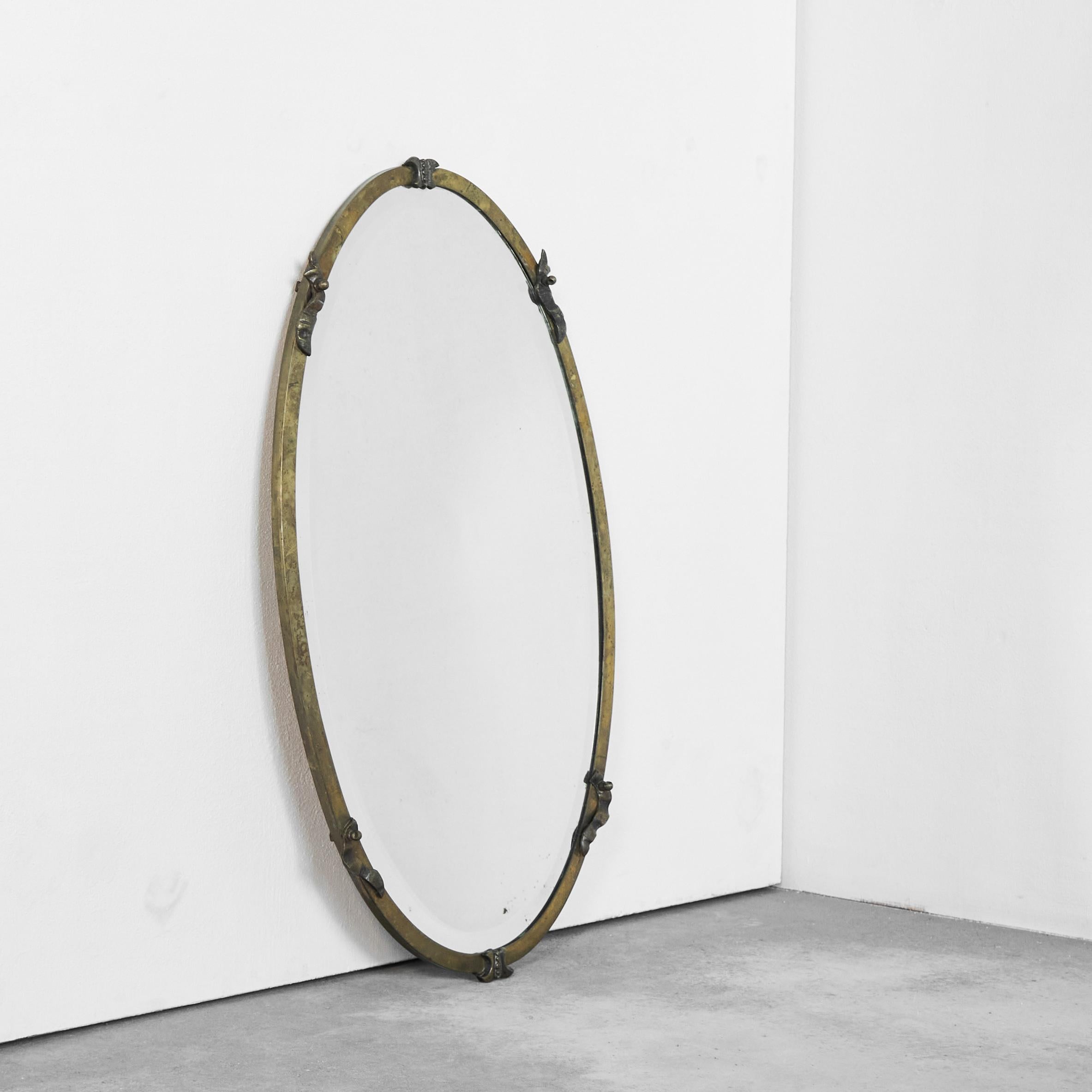 Oval Art Deco Mirror in Patinated Brass, Europe, 1930s.

This is a wonderful oval art deco wall mirror in beautifully patinated brass with intricate details. Versatile shape and size. Very refined with lots of interesting details like the brass