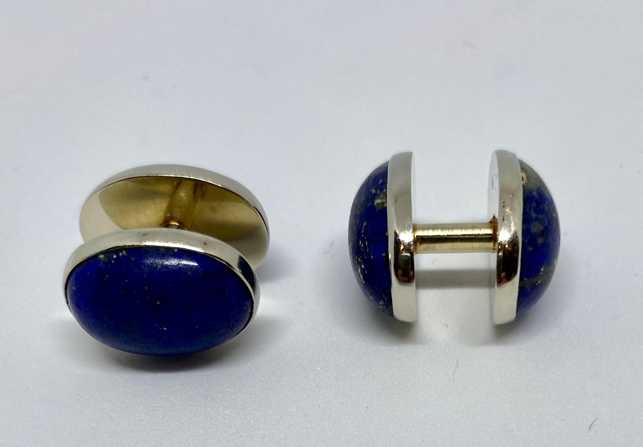 Beautiful, unusually large Art Deco cufflinks in solid 14K white gold with unpolished, oval-shaped lapis cabochons. The spool design was created in the Art Deco period and remains popular for its simplicity and ease of insertion and removal from the
