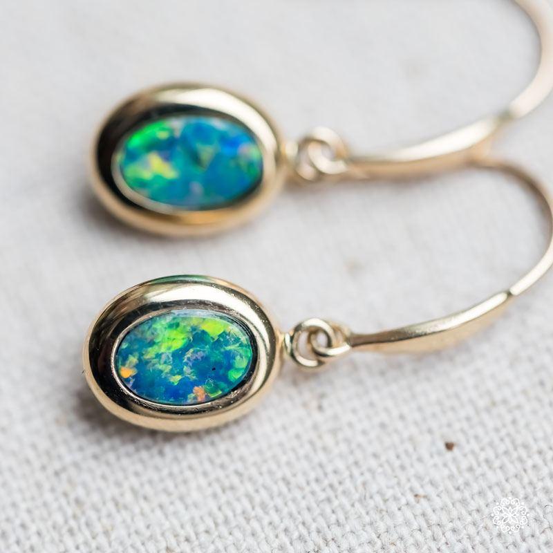 Oval Natural Australian Doublet Opal Drop Earrings in 14k Yellow Gold.


Free Domestic USPS First Class Shipping!  Free One Year Limited Warranty!  Free Gift Bag or Box with every order!



Opal—the queen of gemstones, is one of the most beautiful