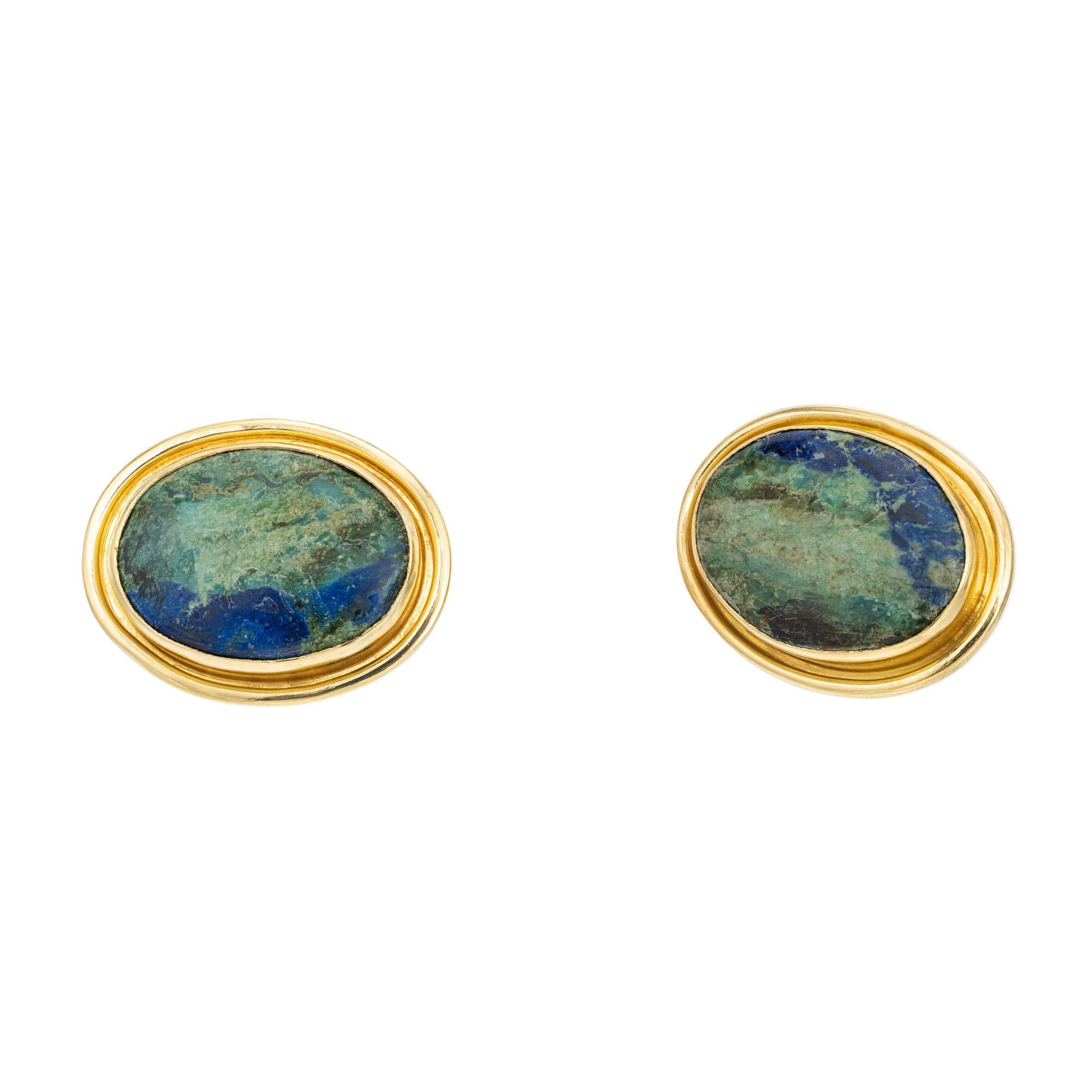 Oval Azurite Malachite gold clip post earrings. Two oval green and blue oval cabochon Azurite Malachite gemstones mounted in 22k yellow gold settings. The rich blend of azurite and malachite stones contrast beautifully against the lustrous yellow