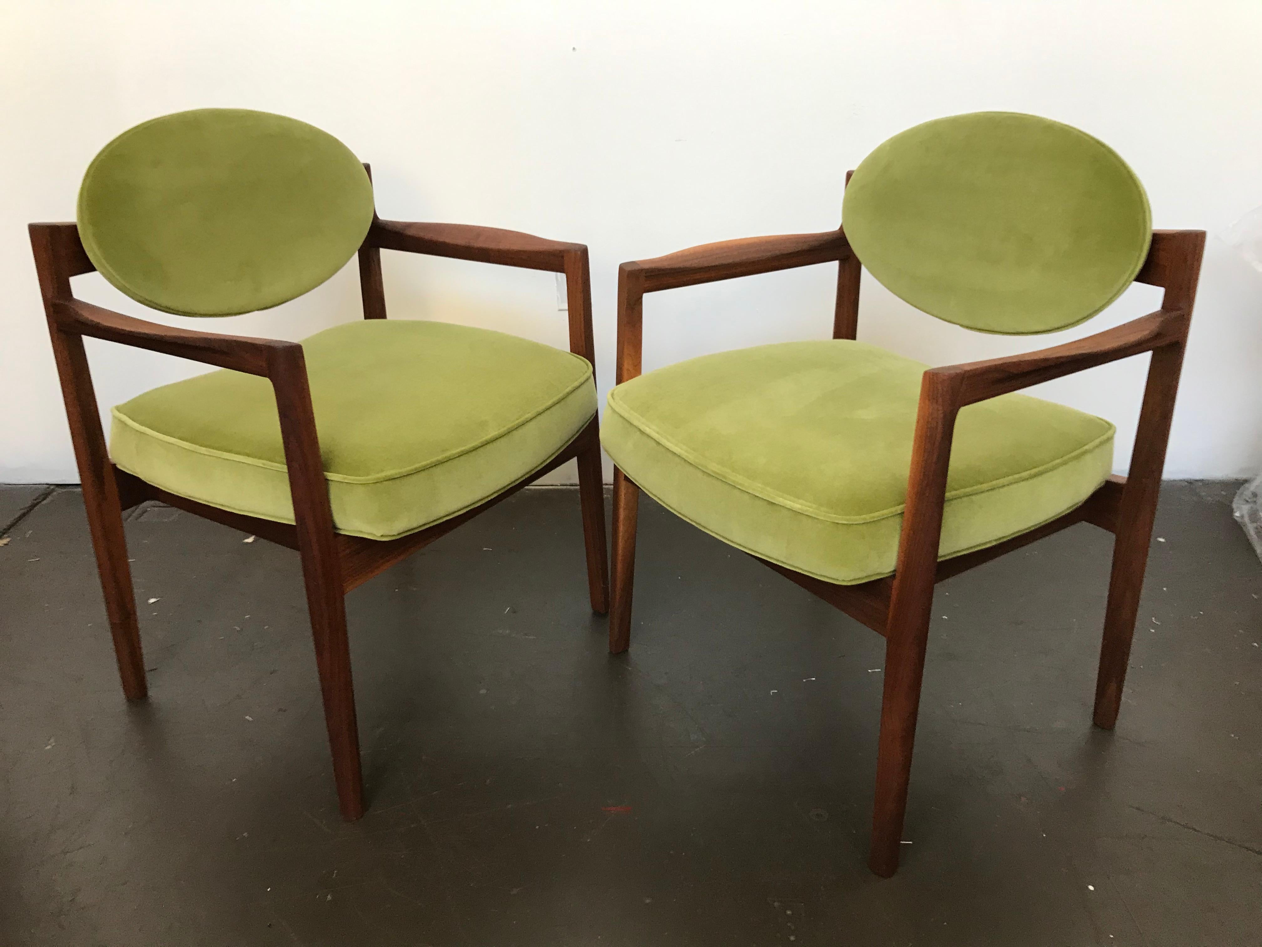 Beautiful set of oval-back armchairs in by Jens Risom designed armchairs, circa 1960s. The refinished oiled walnut frames reveal beautiful woods grain. Re-upholstered in sage green velvet. Nice sculpted flared armrests and floating backs with this