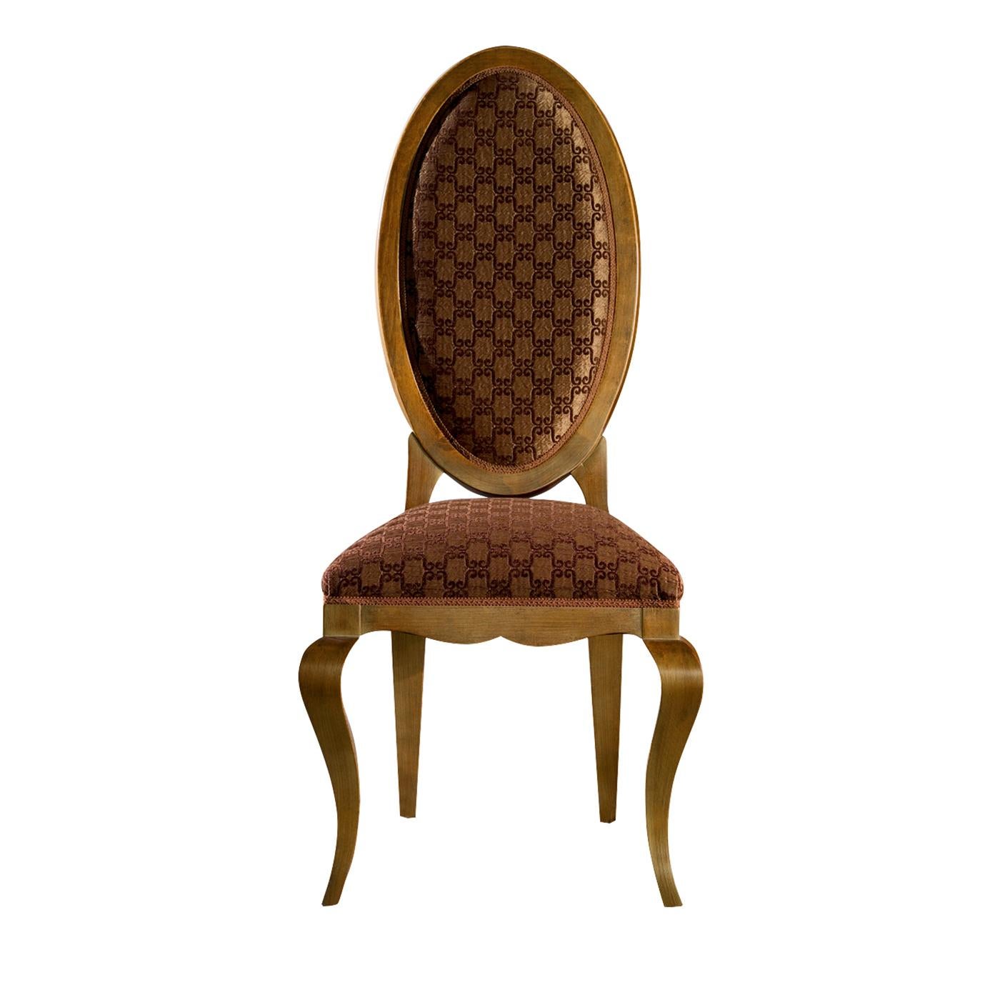 From the contemporary collection, this classic and elegant chair has a wooden frame and features a prominent oval-shaped back that gives the entire seat a slender and tapered form. The seat and back are padded and upholstered in fabric in shades of