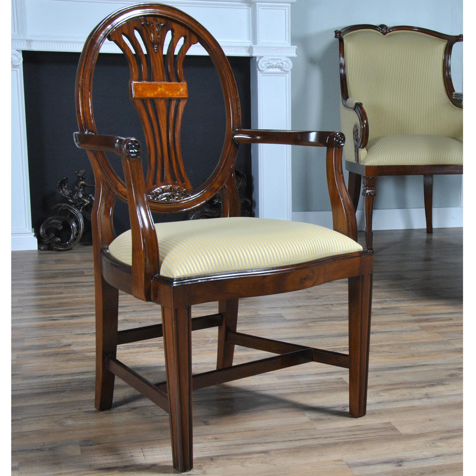 A Set of 10 Oval Back Inlaid Chairs with 2 arm chairs and 8 side chairs. These chairs feature great design and high quality workmanship and materials. A super look featuring scrolled and shaped arms, hand inlaid design in the center of the back