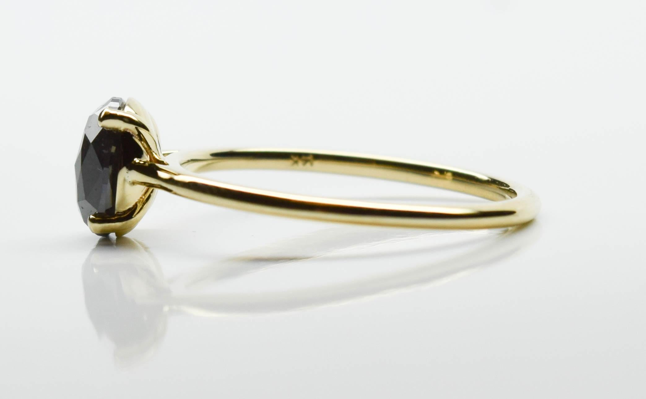 Stunning black diamond ring in 14KT yellow gold, modern slick design with a unique rose cut black diamond solitaire!

Main Stone Shape:Oval Rosecut
Metal:Yellow Gold 14KT 
Diamond Color:BLACK
Diamond Clarity:NA
Diamond Cut:Very Good
Metal