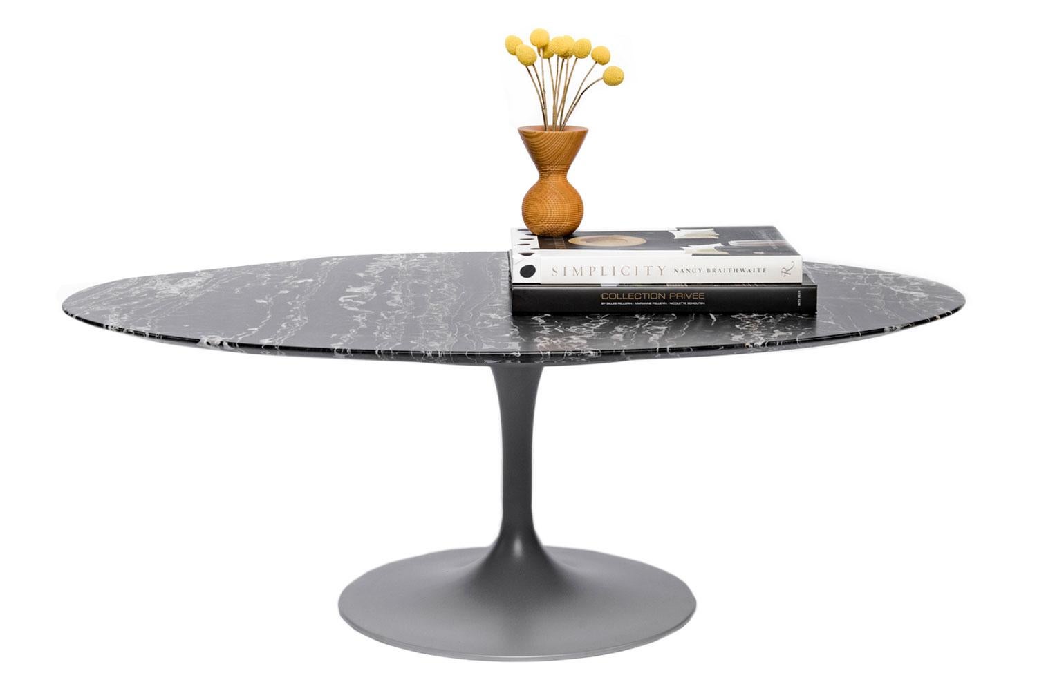 Saarinen coffee table 43” oval By Knoll
Eero Saarinen 1957

This collection is a defining accomplishment of modern design and a timeless piece for Knoll. This Saarinen Coffee table finish a matte grey base with Portoro black marble satin