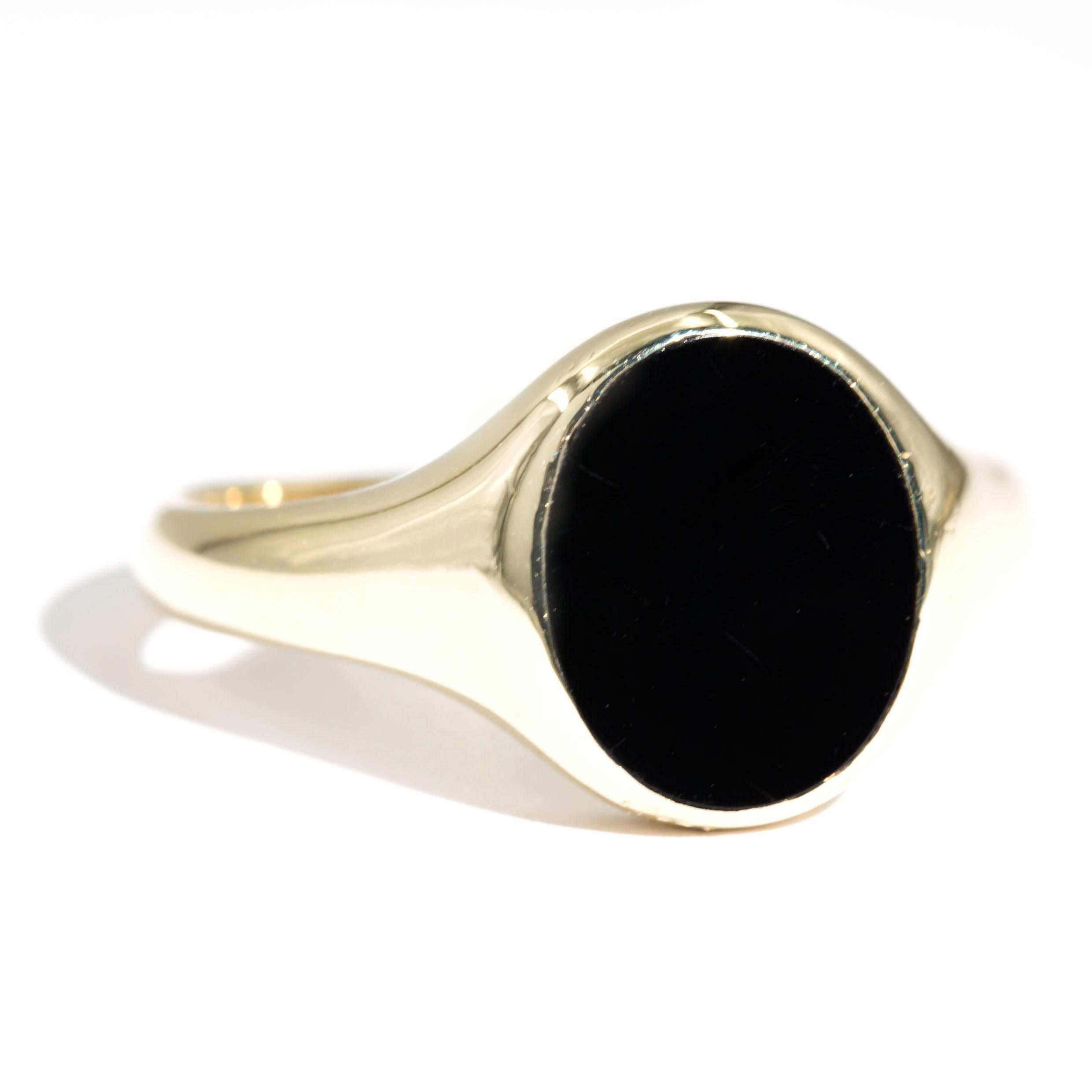 Crafted in 9 carat yellow gold is this handsome vintage mens signet ring featuring a 11.8x9.8 millimetre oval black onyx set in flat oval top. We have named this handsome piece The Roman Ring. The Roman Ring has a high polished band and is perfectly