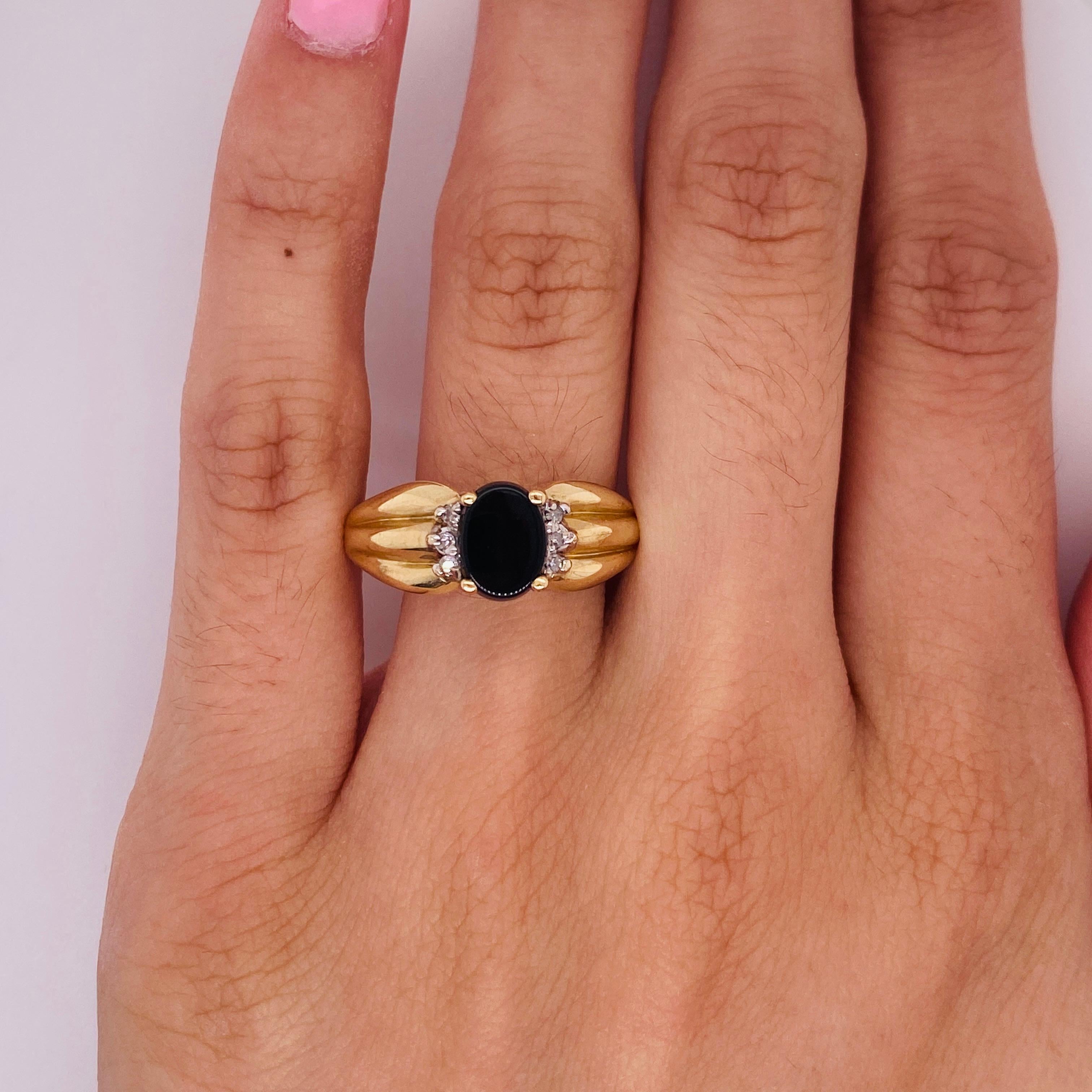 This ring could be perfect for your lover of sleek sophistication! The black onyx gemstone speaks of strength and hidden depths while the curves of the oval speak of fluid grace. Centered by the ribbed shoulders of the ring, the 0.63 carat onyx
