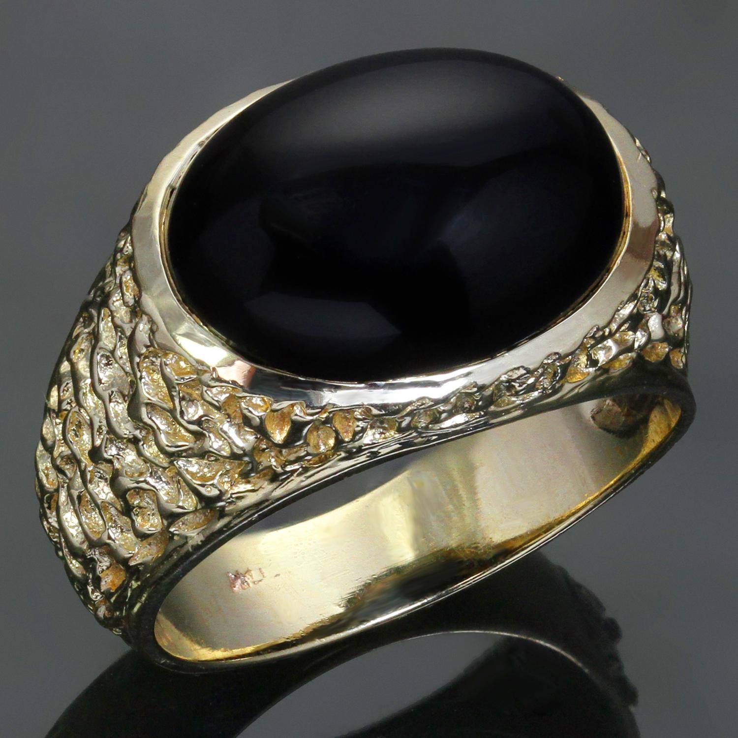 This classic estate men's ring features a large oval black onyx stone set in nugget-textured 14k yellow gold. Made in United States circa 1970s. Measurements: 0.70