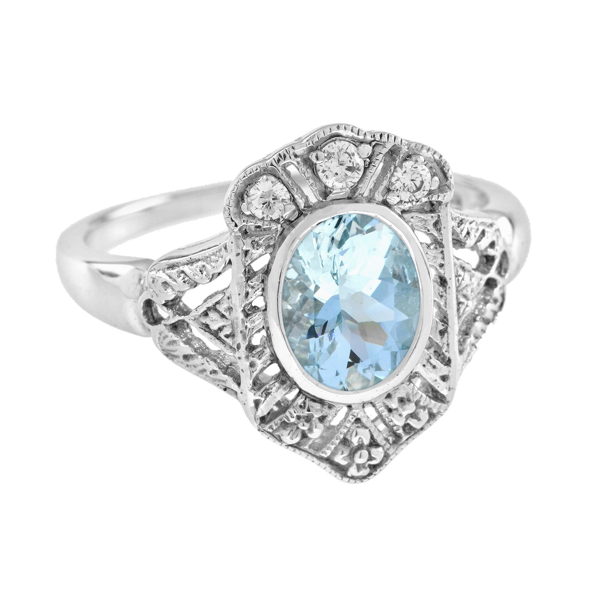 A stunning Art Deco Inspired Aquamarine and Diamond White Gold Ring! The 1.5 carat oval shaped aquamarine is bezel set sitting atop a balanced dispersion of old cut diamonds that total 0.084 carat. This Art Deco inspired ring is a perfect piece for