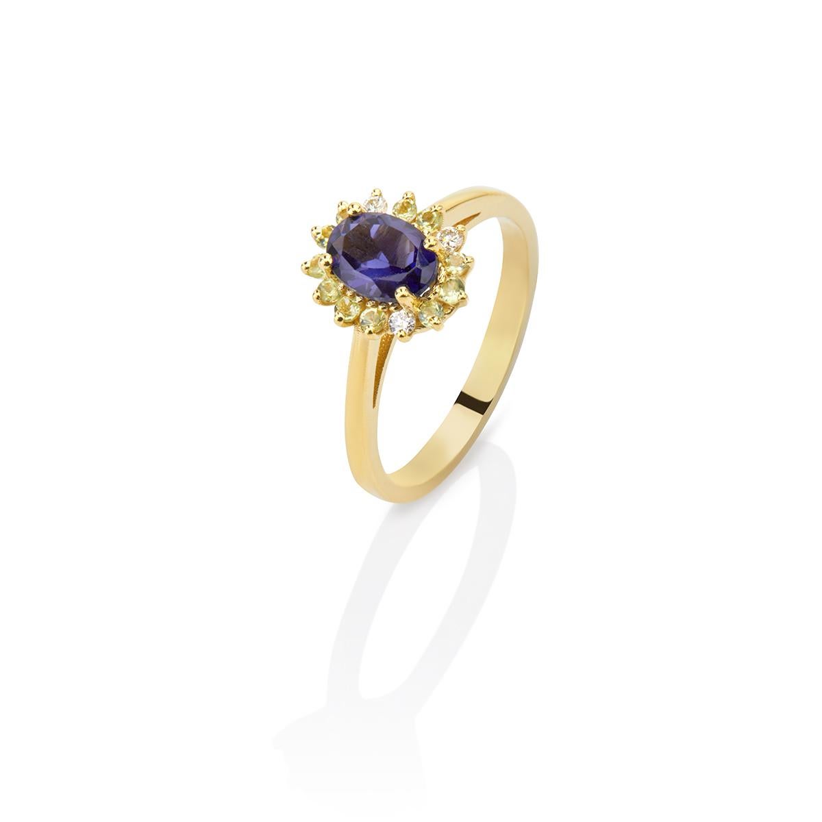 Oval Blue Iolite Green Peridot and Diamonds Cluster Ring in 18Kt  Yellow Gold
The Iolite is carefully set among four yellow gold prongs while the Peridot and the brilliant cut diamond halo around the beautiful blue stone illuminates this ring adding