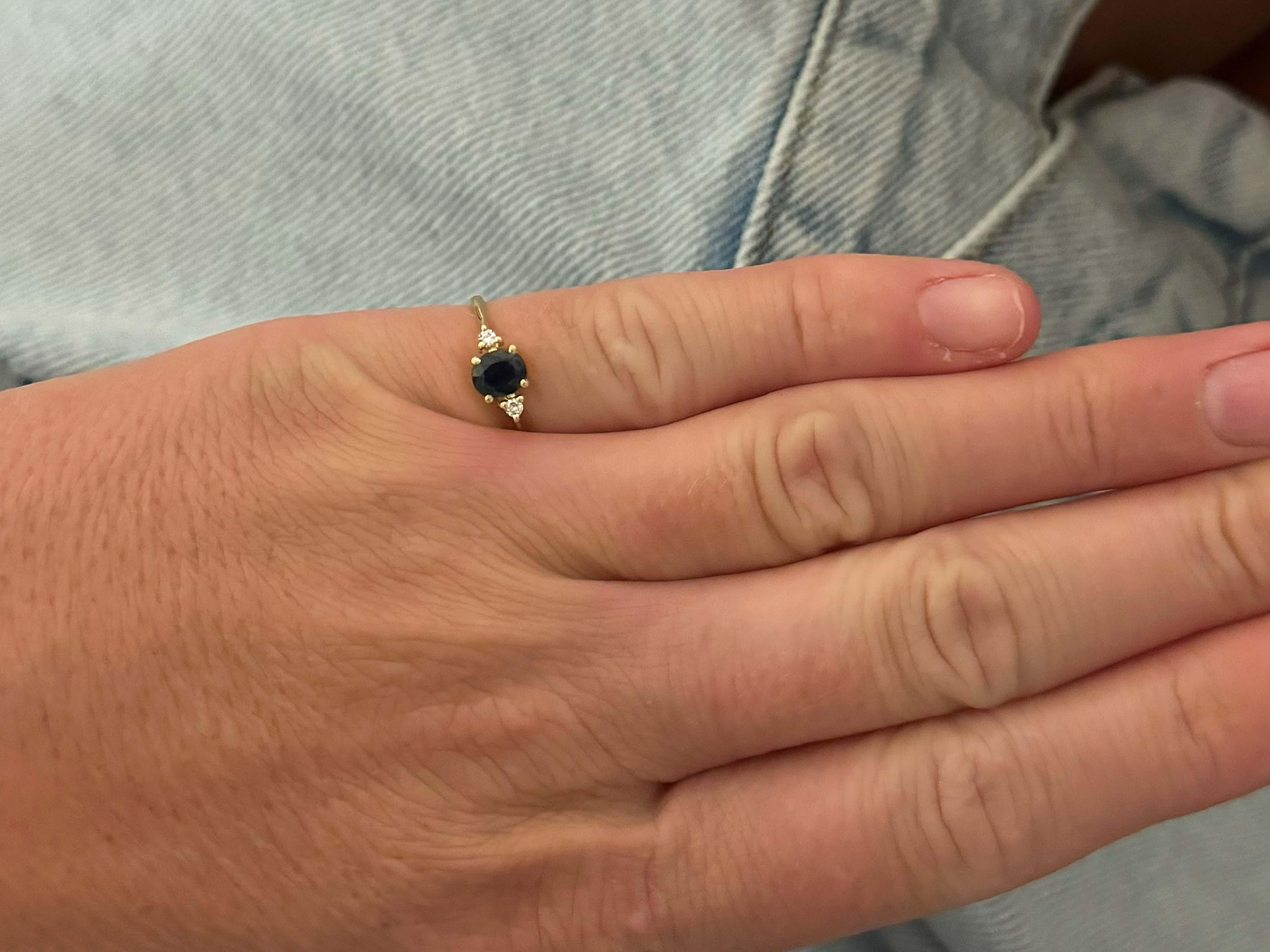 Item Specifications:

Metal: 14K Yellow Gold

Total Weight: 1.7 Grams

Ring Size: 4.5

Sapphire Carat Weight: ~0.60 carats

Sapphire Measurements: 5.4 mm x 4.6 mm x 3.1

Diamond Count: 2 brilliant cut

Diamond Color: H-I

Diamond Clarity: