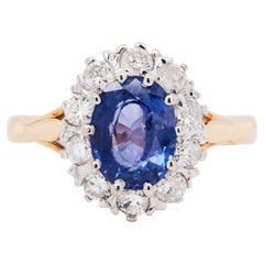 Oval Blue Sapphire and Diamond Halo 18K Gold Coronet Cluster Engagement Ring