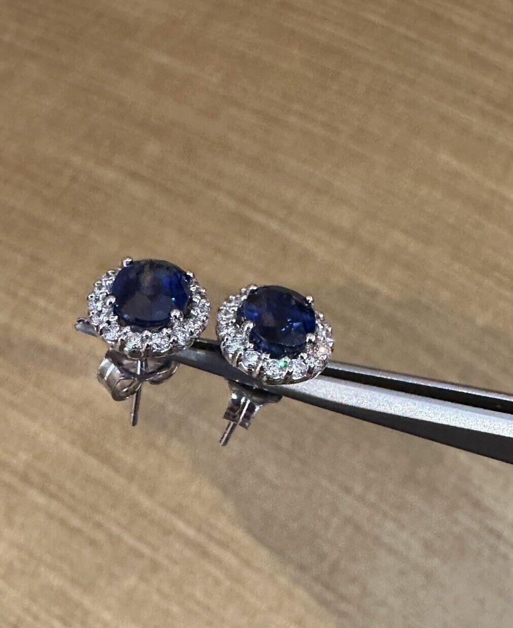 Oval Blue Sapphire and Diamond Halo Earrings in 14k White Gold 

Diamond and Sapphire Earrings feature two Natural Oval Deep Blue Sapphires encircled by a halo of Round Brilliant Diamonds, set in 14k White Gold.

Total sapphire weight is 3.37