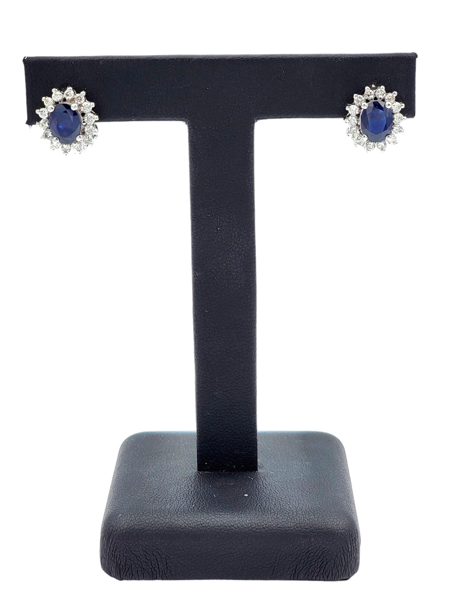 Women's Oval Blue Sapphire and Diamond Halo Stud Earrings in 14 Karat White Gold For Sale