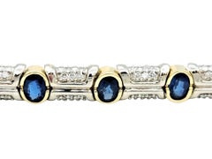 Oval Cut Blue Sapphire and Diamond Line Bracelet in Two-Tone 14 Karat Gold