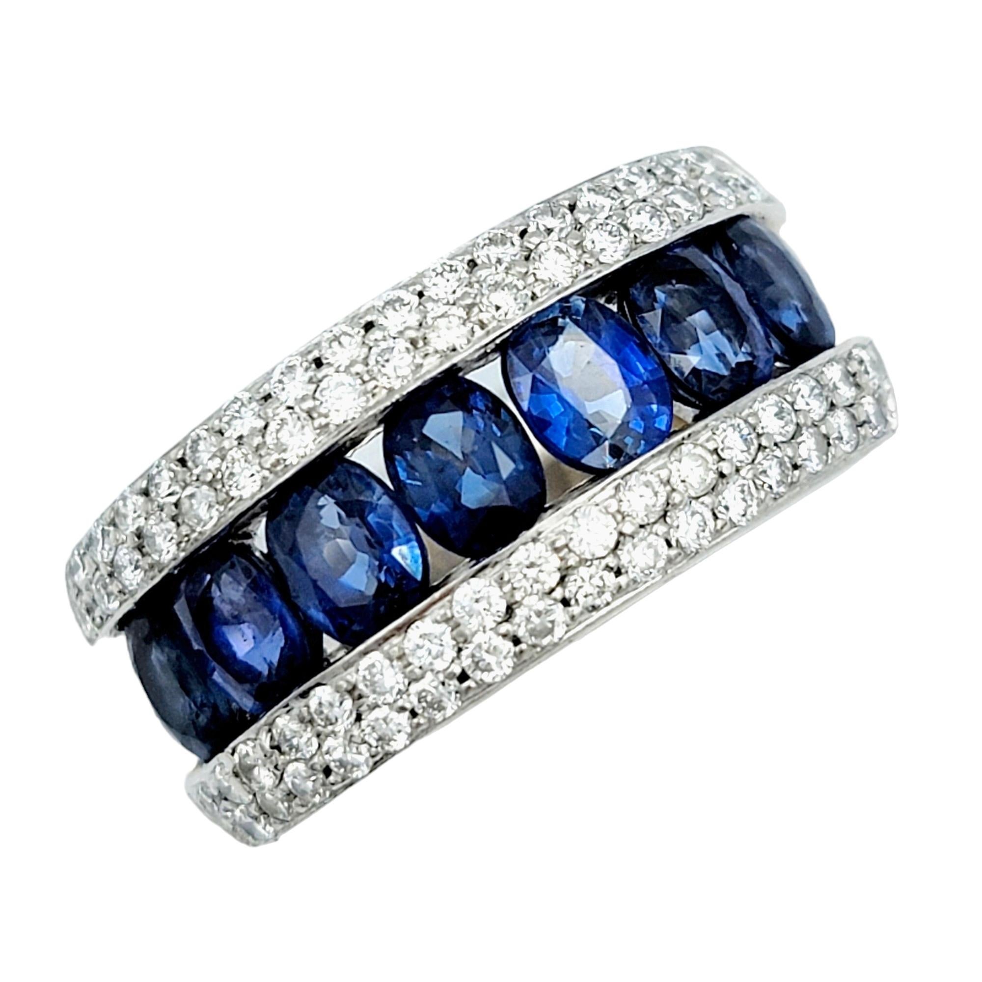 Ring Size: 6.25

This captivating band ring is a sophisticated and stunning work of art. Crafted with precision, the ring features a series of exquisite oval blue sapphires channel-set between delicate pave diamonds, creating a harmonious blend of