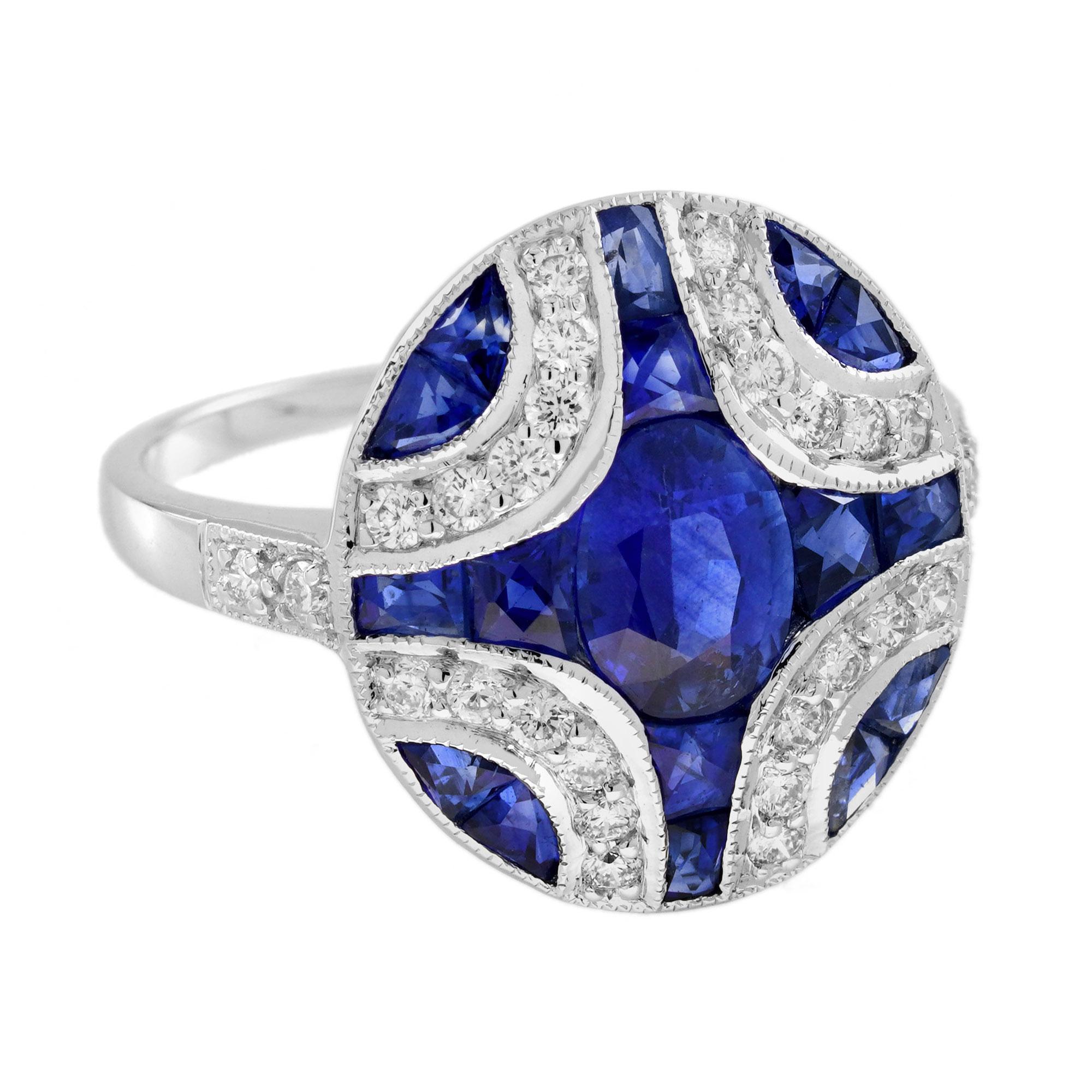 Une jolie bague de style Art déco en saphir bleu et diamant en monture milgrain centrée par un saphir ovale d'environ 1,10 carat orné d'autres saphirs de taille française flanqués d'une ligne de diamants ronds de taille brillant à chaque coin. Cette