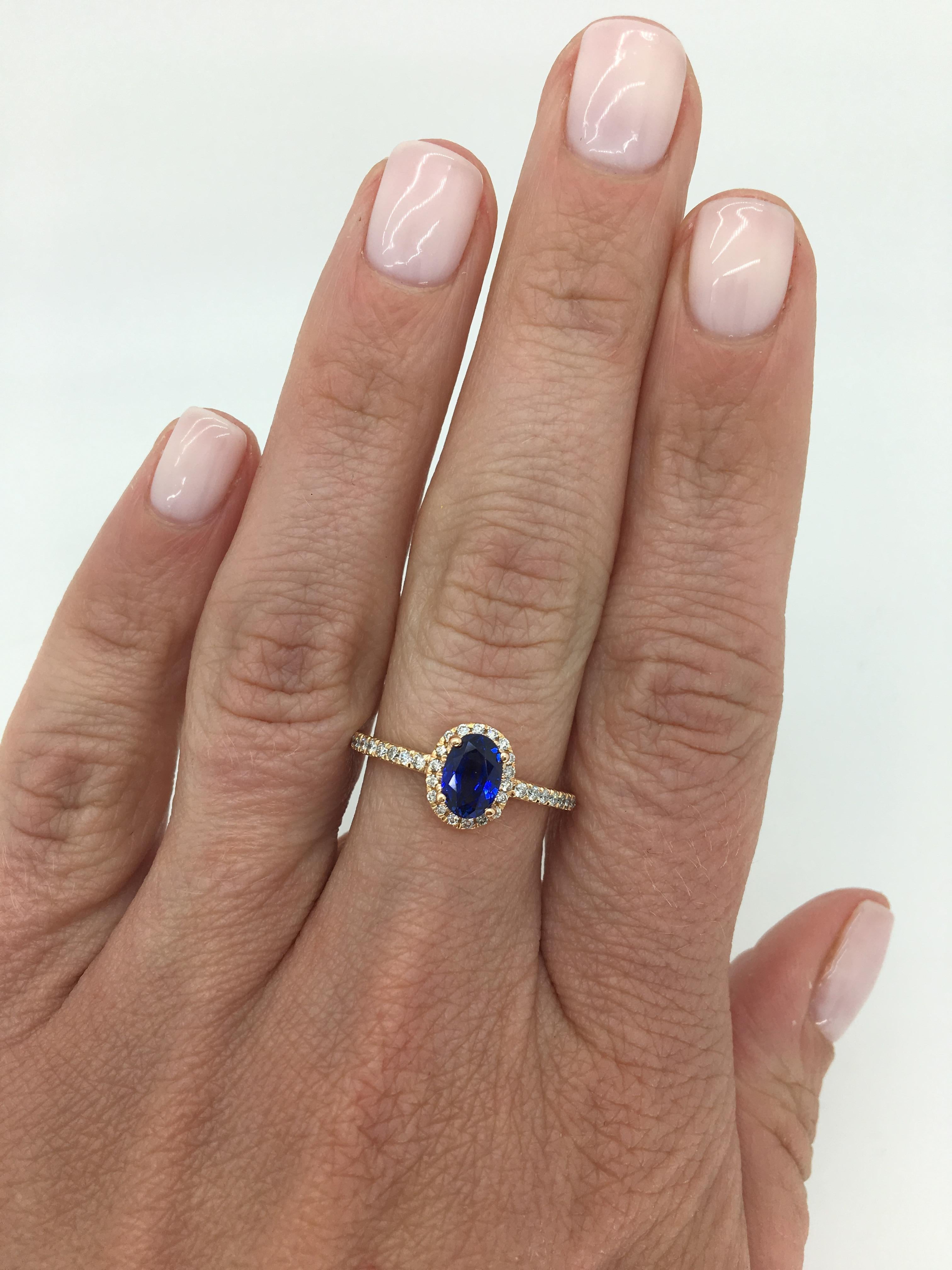 Oval Cut Blue Sapphire and diamond halo style ring crafted in 14K rose gold.

Gemstone: Blue Sapphire and Diamond
Gemstone Carat Weight: Approximately 1.07CT Oval Cut
Diamond Carat Weight: Approximately .25CTW
Diamond Cut: Round Brilliant Cut
Color: