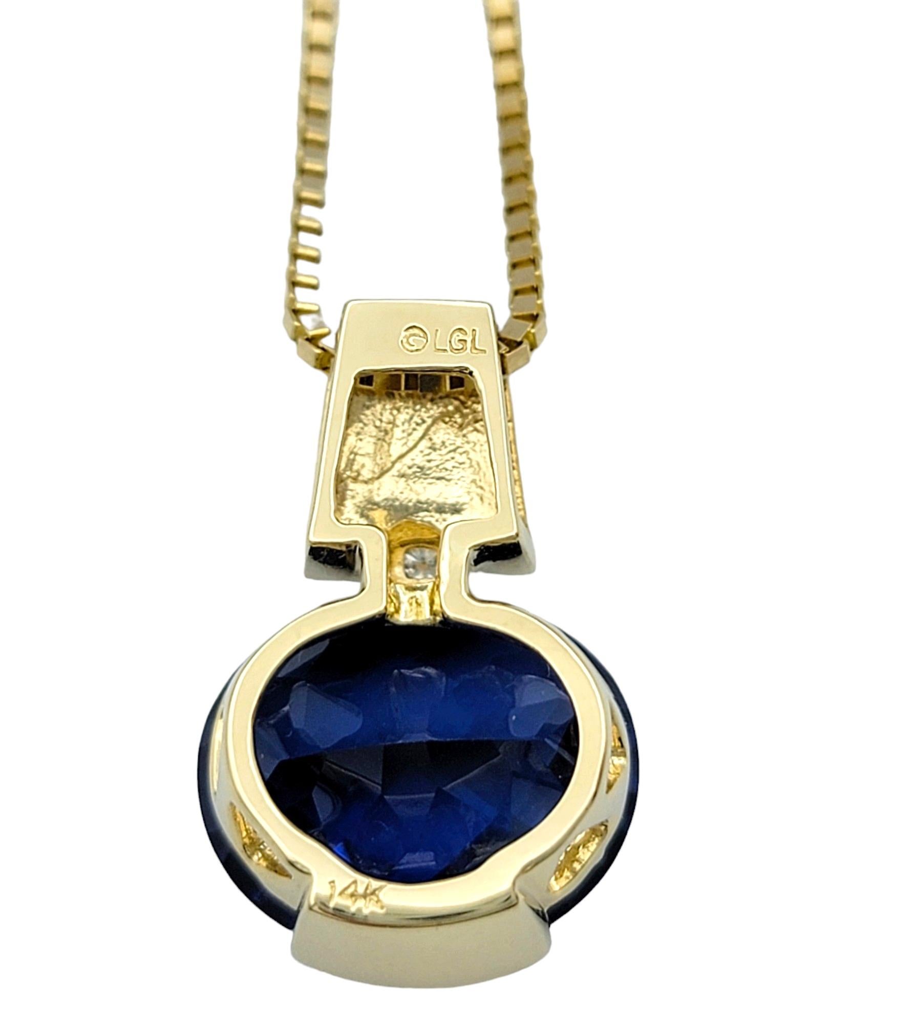 Oval Blue Synthetic Sapphire and Natural Diamond 14 Karat Gold Pendant Necklace In Good Condition For Sale In Scottsdale, AZ