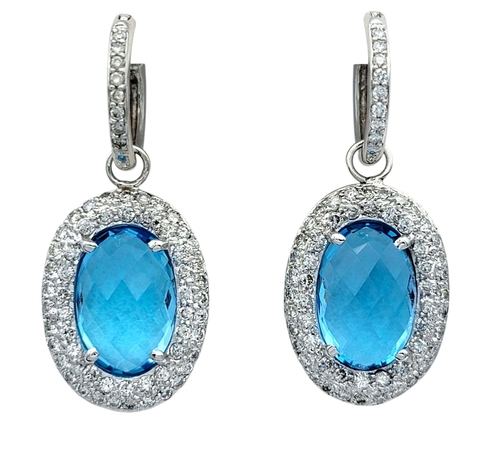 Elevate your style with these exquisite 14 karat white gold convertible earrings, designed to transition seamlessly between statement-making glamour and understated sophistication. Each earring features a dazzling oval checkerboard-cut blue topaz,