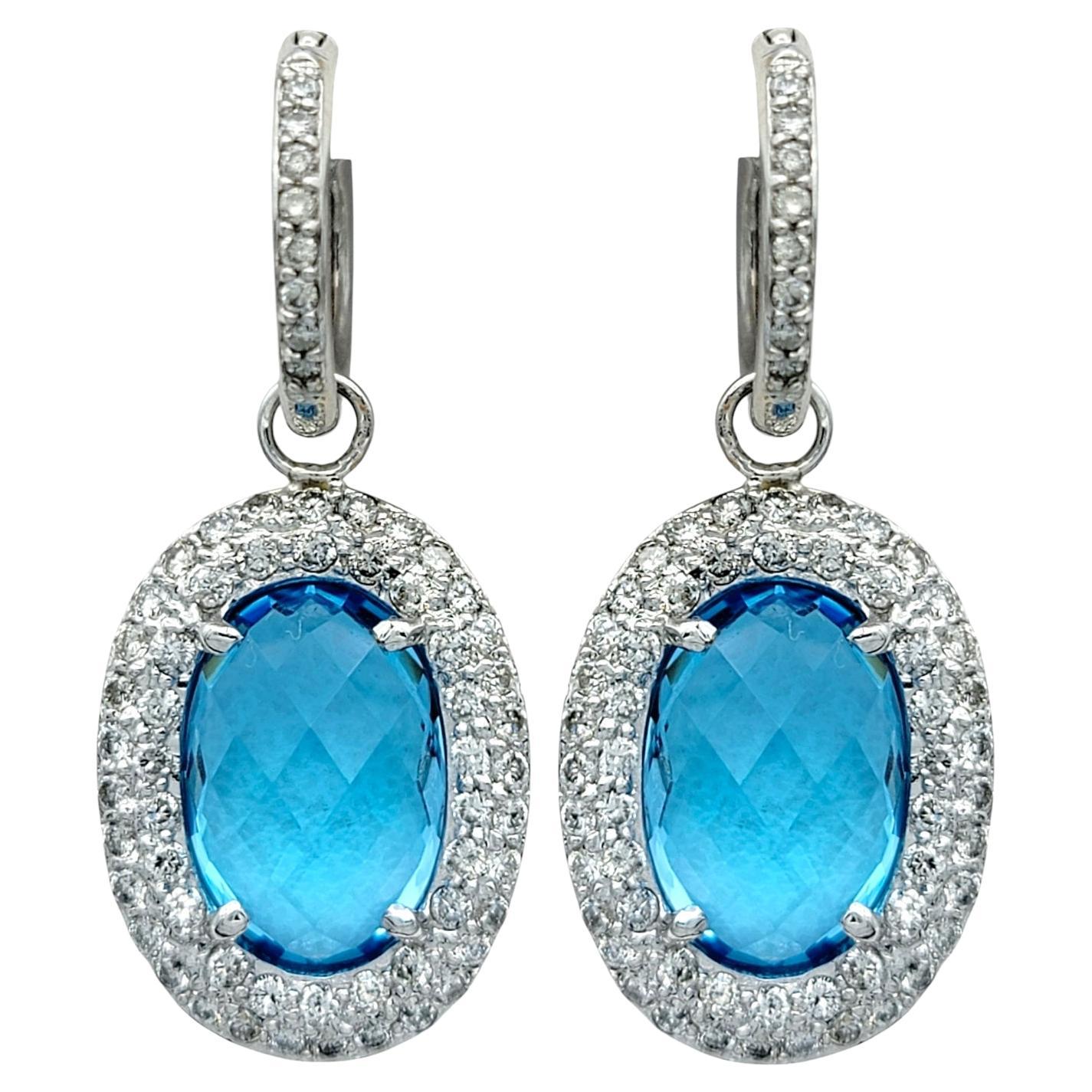 Oval Blue Topaz and Diamond Halo Huggie Dangle Earrings in 14 Karat White Gold