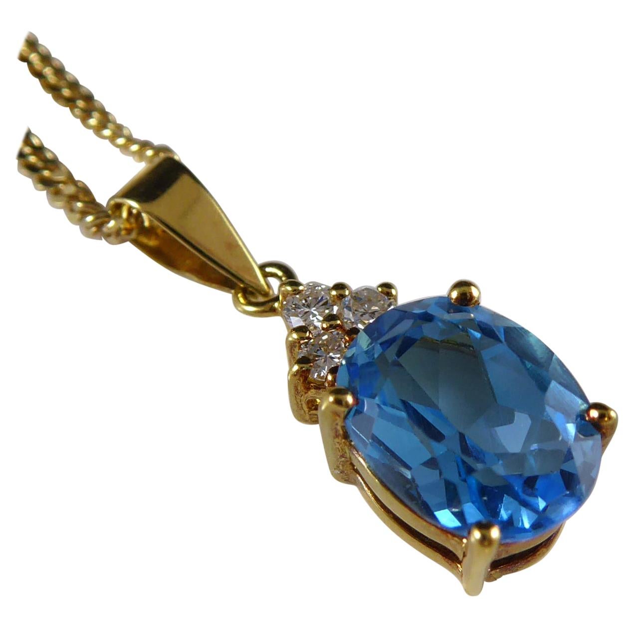 Oval Blue Topaz and Diamond Pendant on Chain, Yellow Gold