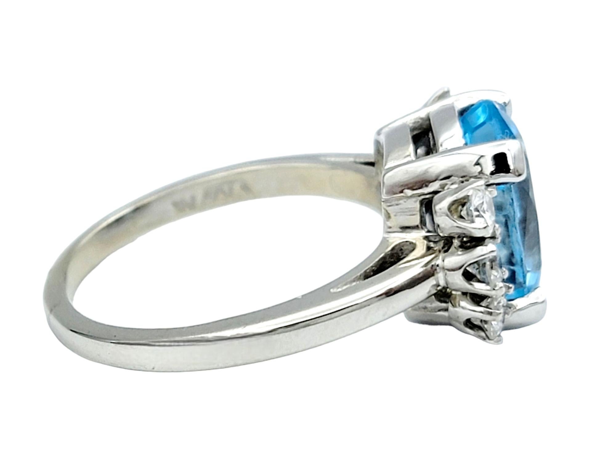 Contemporary Oval Blue Topaz and Round Diamond Flanked Cocktail Ring in 14 Karat White Gold For Sale