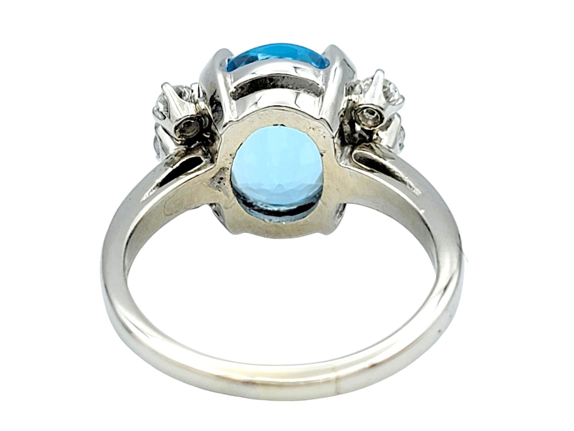 Oval Cut Oval Blue Topaz and Round Diamond Flanked Cocktail Ring in 14 Karat White Gold For Sale