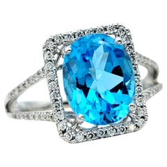 Oval Blue Topaz and Square Diamond Halo Split Shank Ring in 18 Karat White Gold