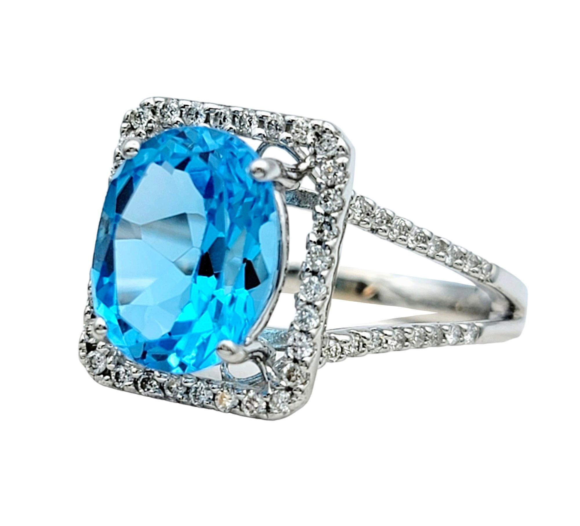 Contemporary Oval Blue Topaz and Square Diamond Halo Split Shank Ring in 18 Karat White Gold For Sale