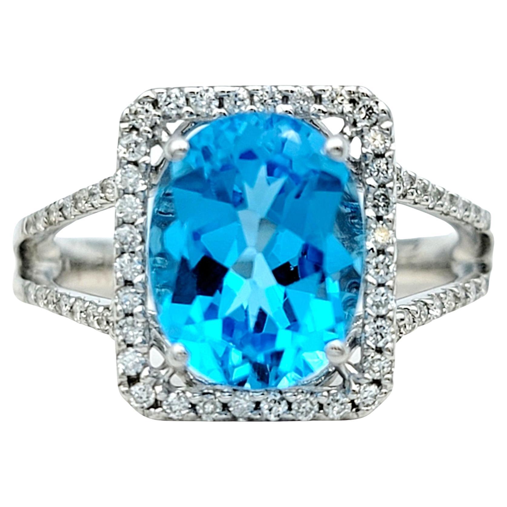 Oval Blue Topaz and Square Diamond Halo Split Shank Ring in 18 Karat White Gold For Sale