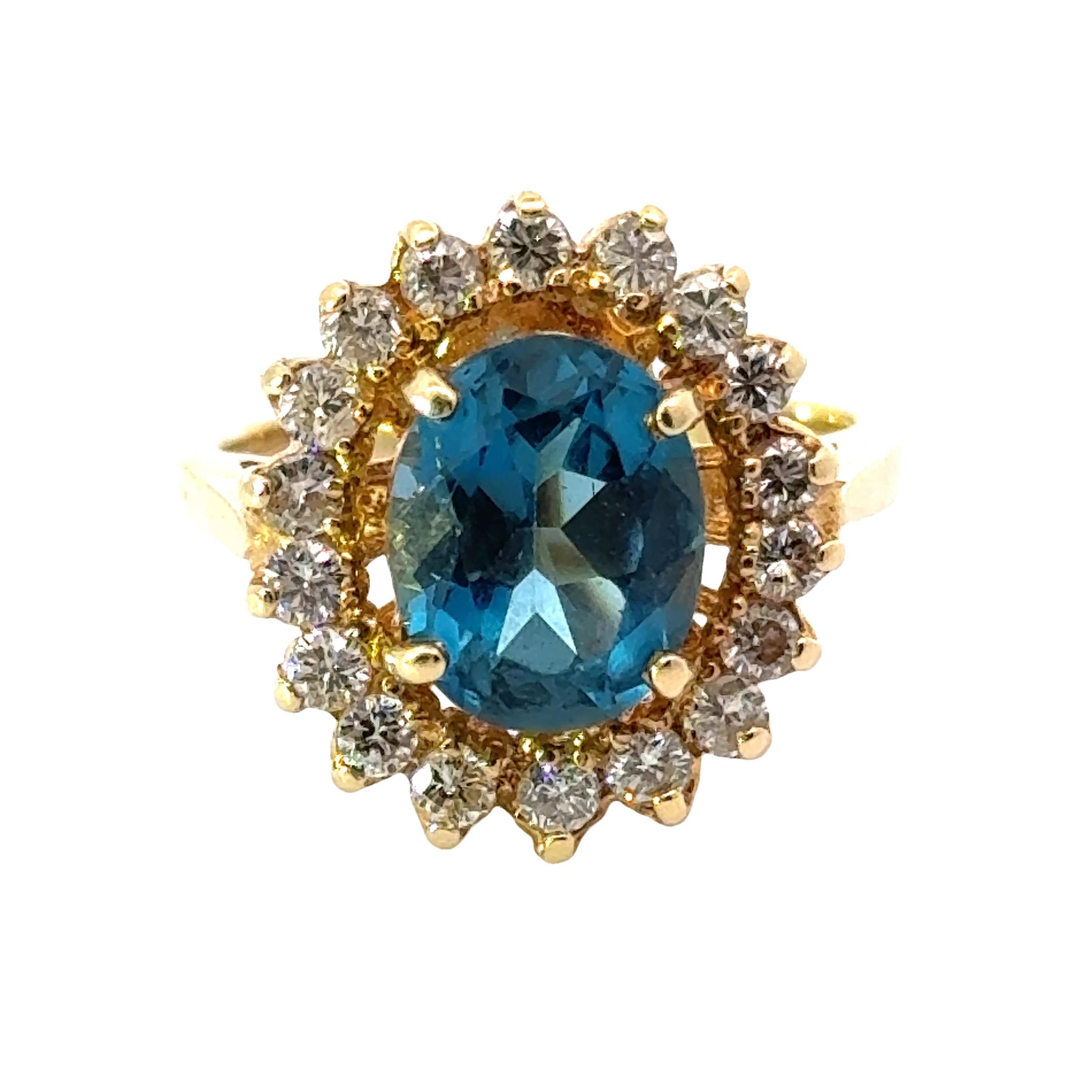 This elegant estate ring showcases a beautiful oval blue topaz gemstone accented with dazzling diamonds, set in 14K yellow gold. Inspired by Princess Diana's iconic style, this ring adds a touch of regal sophistication to any outfit. Handcrafted