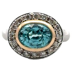 Used Oval Blue Zircon Diamond 14 Karat White 
Yellow Gold Bezel Set Ring