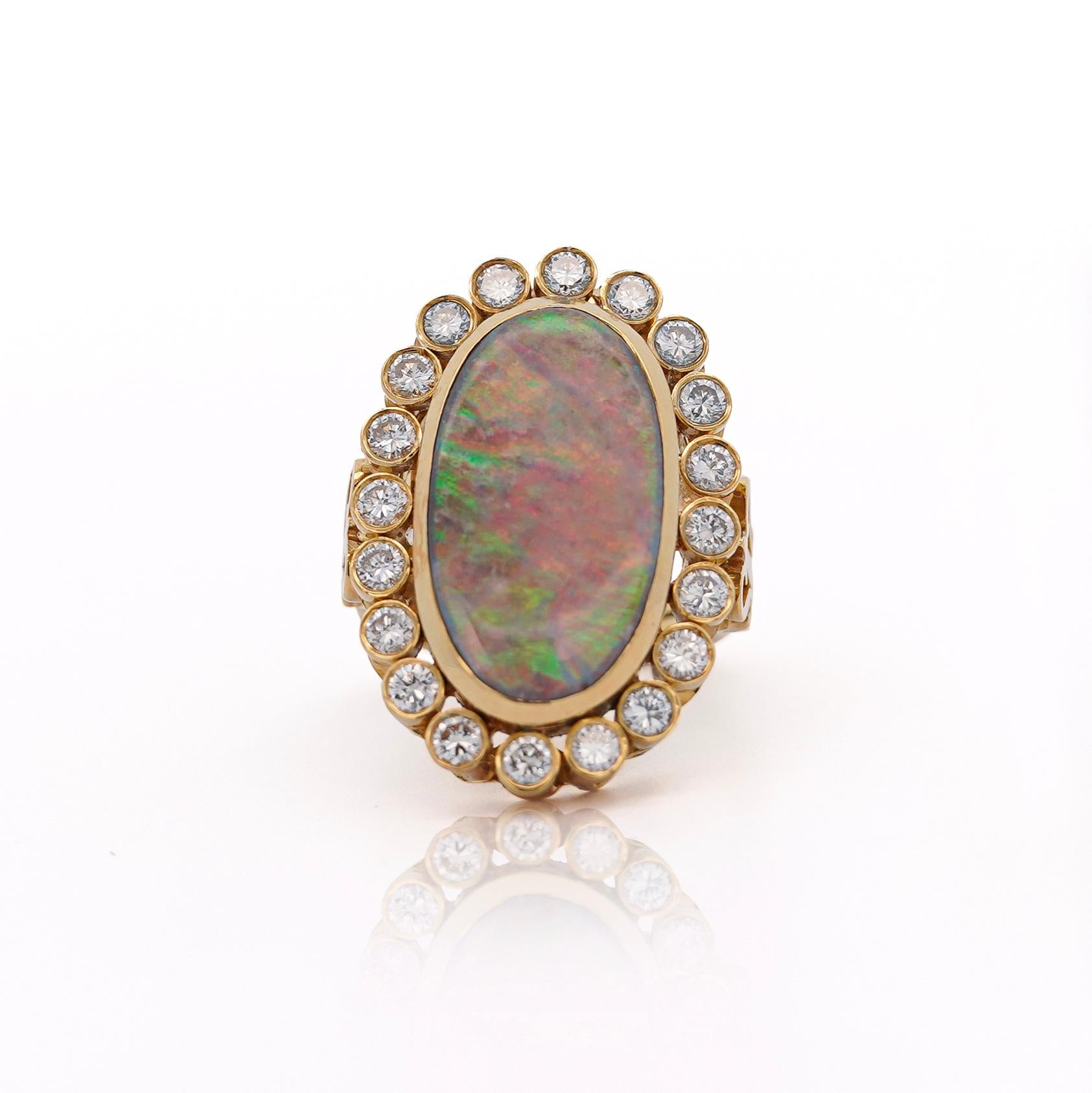 This elegant Vintage Boulder Opal Ring in 18K Yellow Gold showcases a stunning 22 x 11.5 mm opal framed by a halo of 20 round diamonds, offering a timeless and radiant design for collectors and enthusiasts alike.

Breakdown Details:
Item Type: