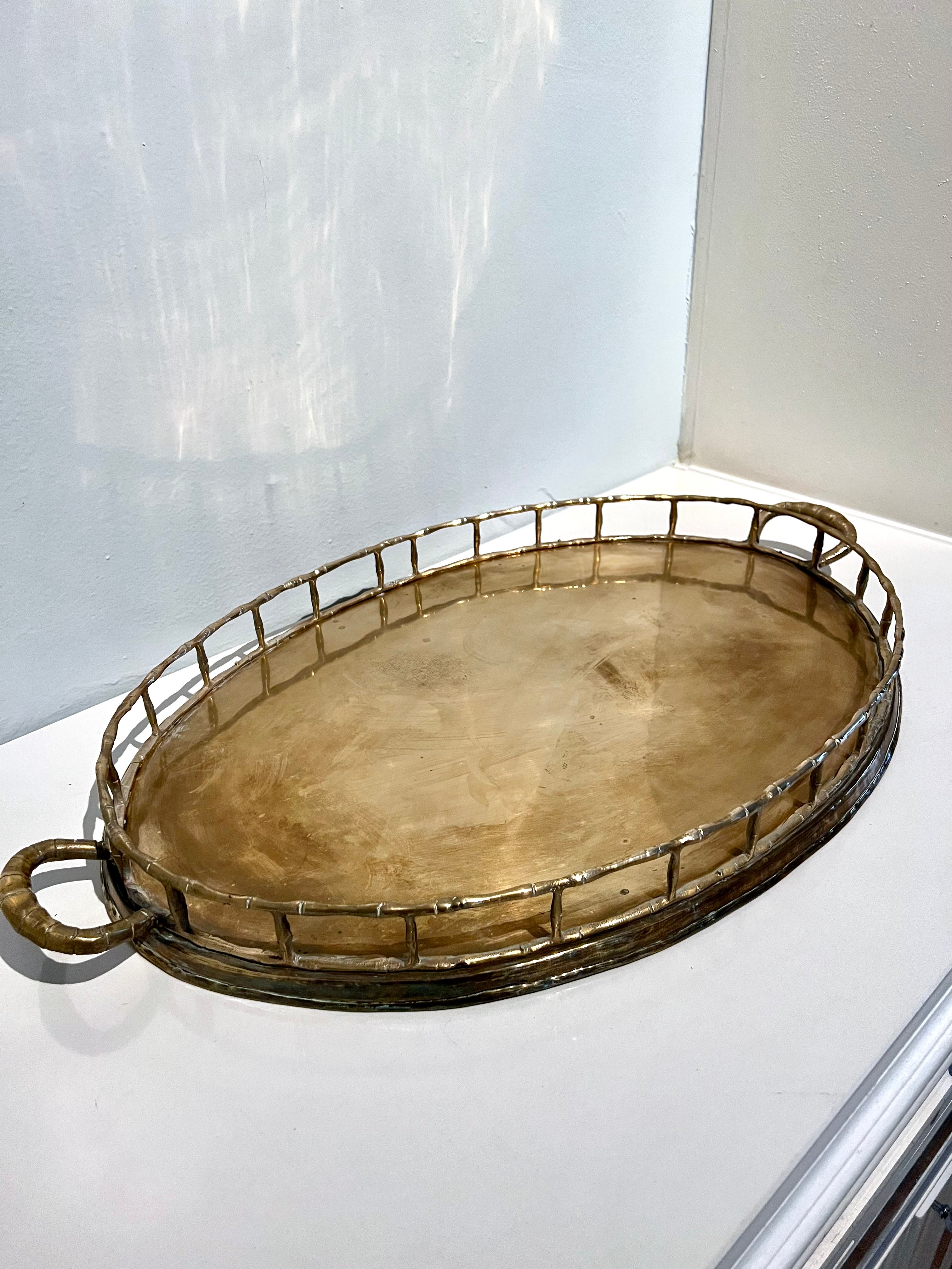 A large vintage Hollywood regency style brass bamboo serving tray. Great for display on coffee tables or serving cocktails. Polished and patinated. 

Our storefront is home to several brass bamboo tray options. Please visit to find the one that