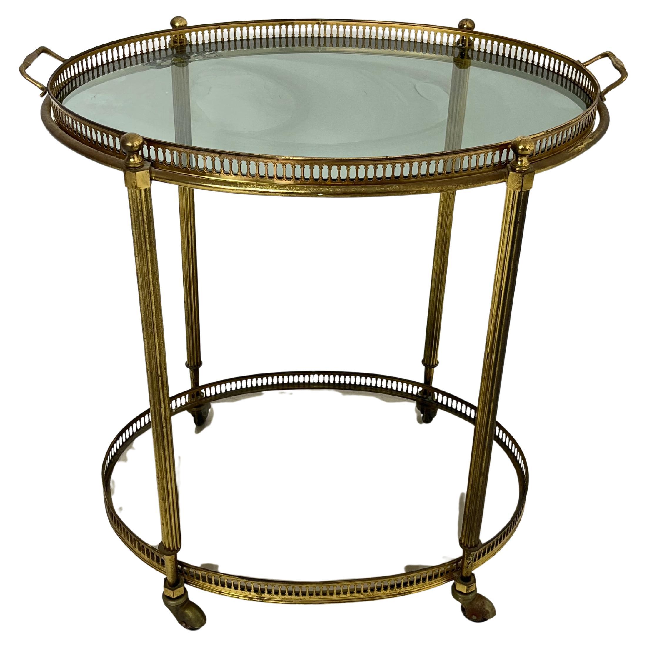 Oval brass bar trolley, Made in Italy, 1950s
Glass shelves, unique for the top shelf, which doubles as a tray.
4 swivel casters.
Good condition, minor signs of wear.