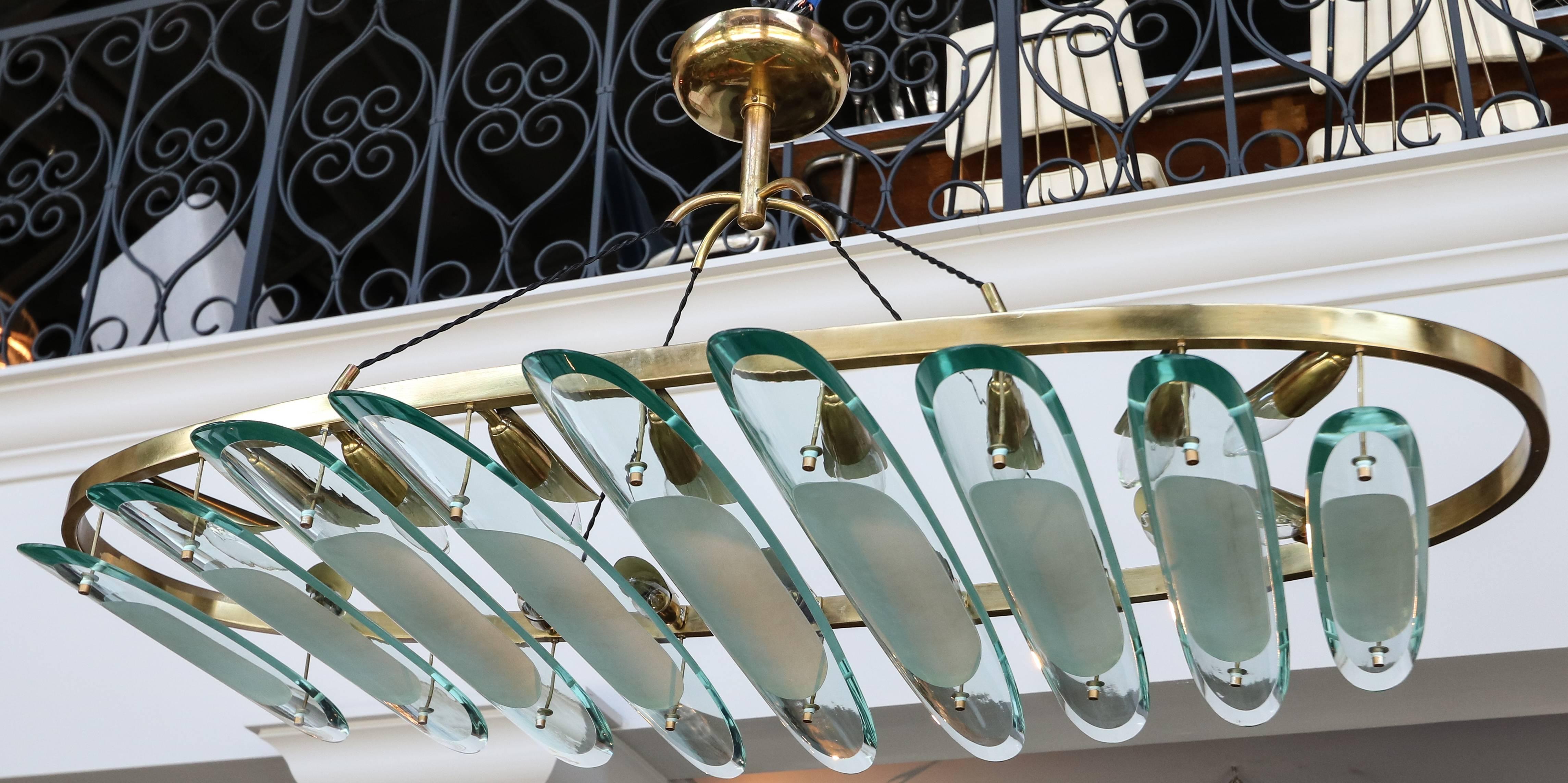 Brass oval chandelier by Fontana Arte for Dominici with clear and sanded glass pieces.