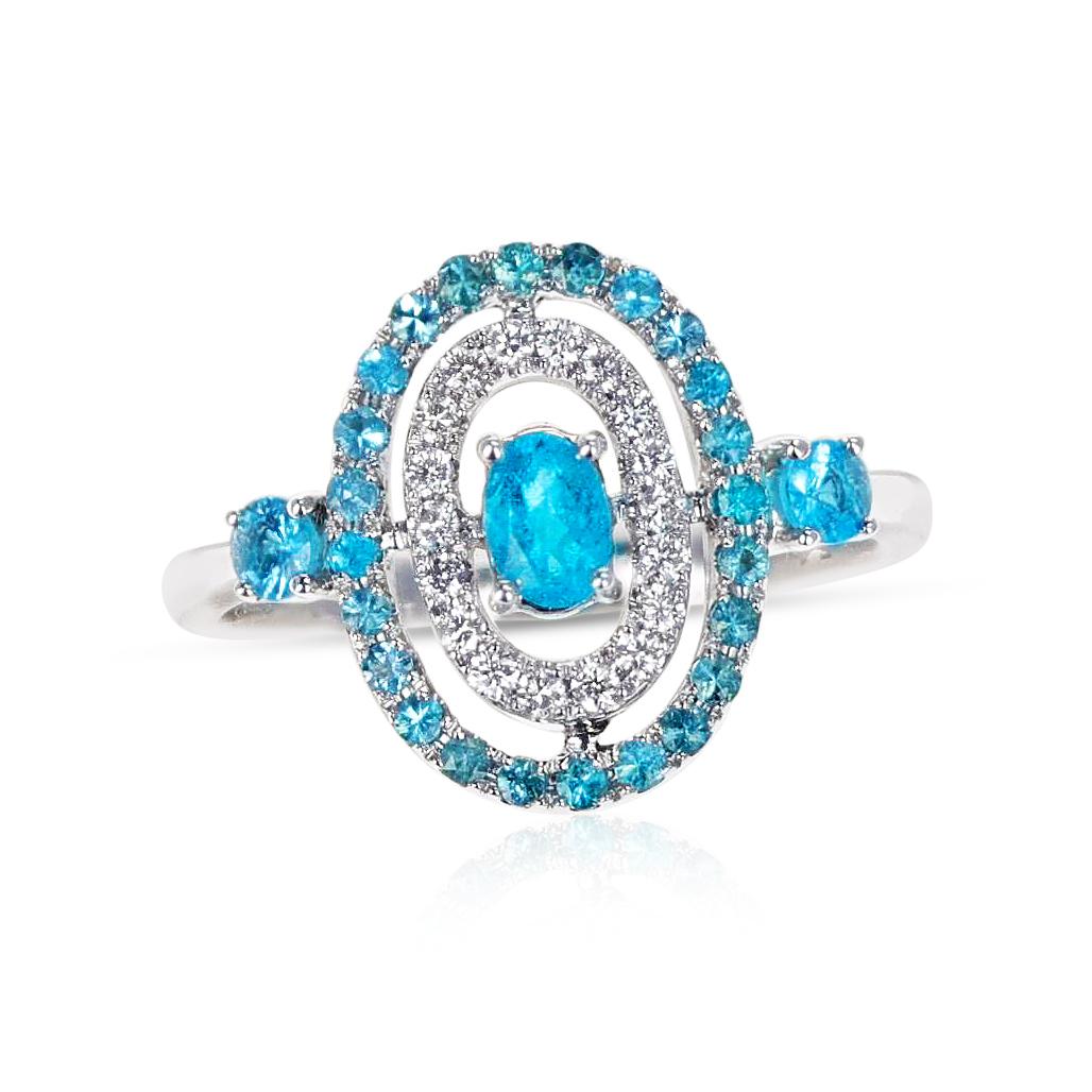 An Oval Brazilian Paraiba Tourmaline Ring with Diamond Halo Ring made in 18 Karat White Gold. The center Paraiba is 0.35 carats, and the side Paraiba are 0.14 carats and 0.21 carats each. The total diamond weigh is appx. 0.19 carats. The ring size