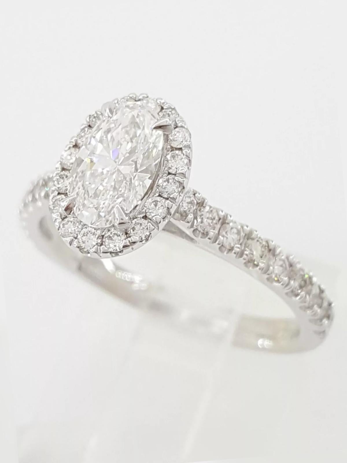 Oval Brilliant Cut Diamond Halo 14k White Gold Engagement Ring. 

The ring weighs 3.1 grams, size 6.75, the center stone is a Natural Oval Brilliant Cut diamond weighing 0.7 ct, E in color, VVS2 in clarity, Good Polish, Good Symmetry & Faint