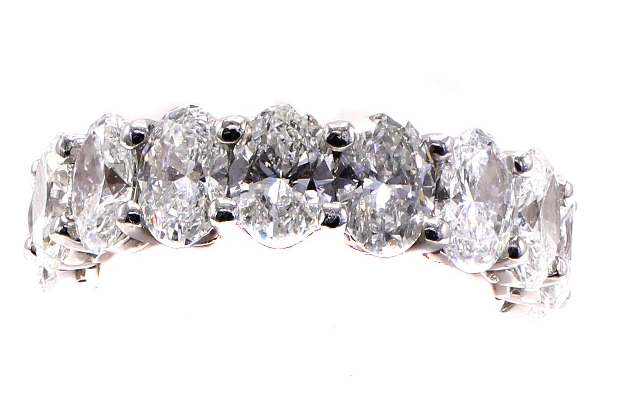 Beautifully handcrafted in platinum this lovely eternity band is set with 16 perfectly matched bright white and sparkly oval brilliant cut diamonds. Each oval cut diamond weighs approximately 0.40 carats making this a quite impressive band and
