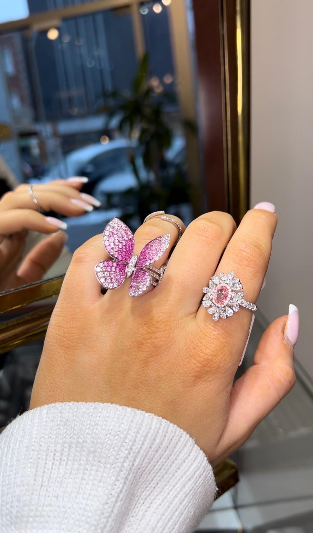 Pink Lovers Alert! A Rare and fabulous Pink Diamond Winston-Style Ring in 18k White Gold. This candy color ring features an Oval-brilliant cut center stone diamond 1.02 carats, 6.72 x 4.98 x 3.49 ct. Fancy Pink clarity grade VVS2. Polish Excellent,