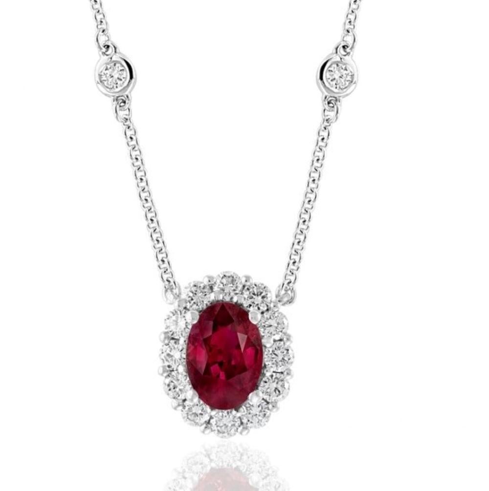 Ruby and Diamond Pendant, One Oval Ruby weighing .71 carats and 16 Round Brilliant Cut Diamonds weighing .48 carats total, 18 karat white gold.

Classic and clean, this highly executed design is easy to wear. With our design of the pendant around