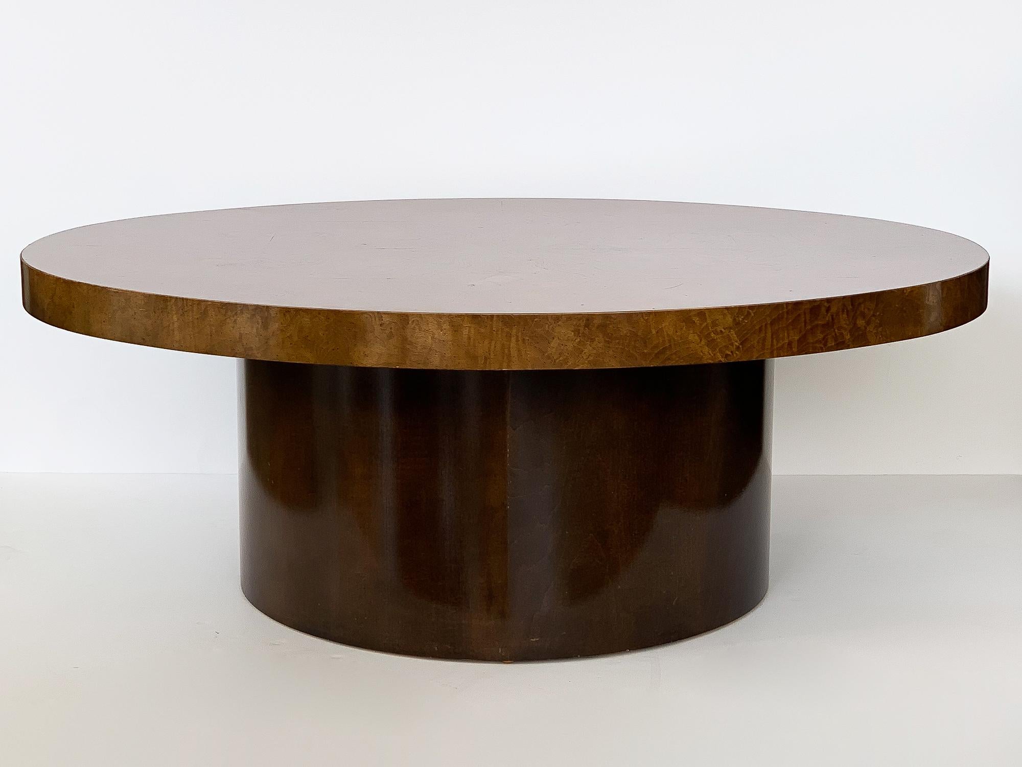 Burl wood oval coffee table with round pedestal base, circa 1970s. Oval shaped top in a bookmatched burl wood veneer. 26