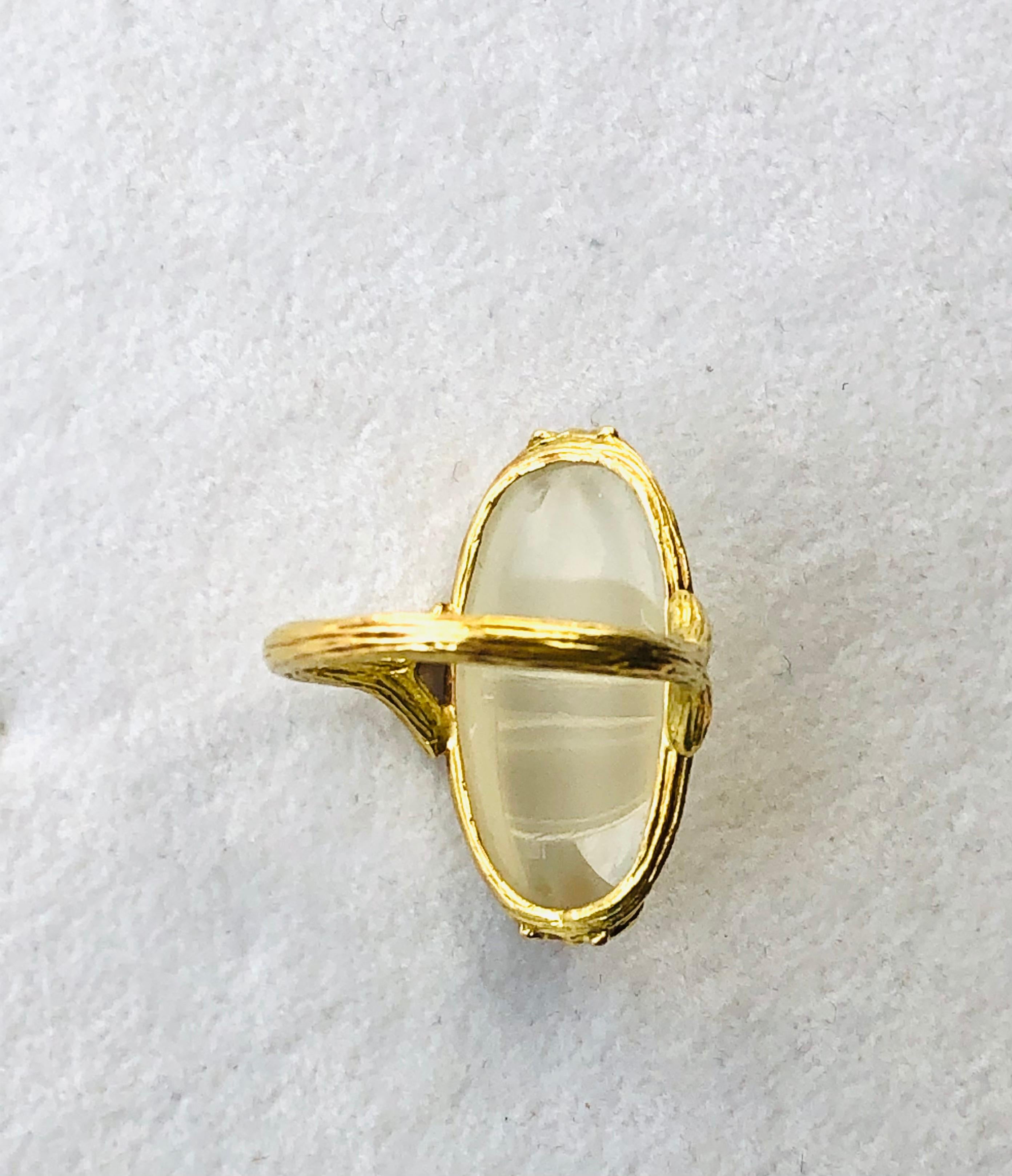Smooth and voluptuous, this elongated oval moonstone cabochon ring offers up a looking-glass that peers into the mysteries of life. Or so it seems. We won't be surprised if you find yourself staring into it off and on throughout the day. But we all