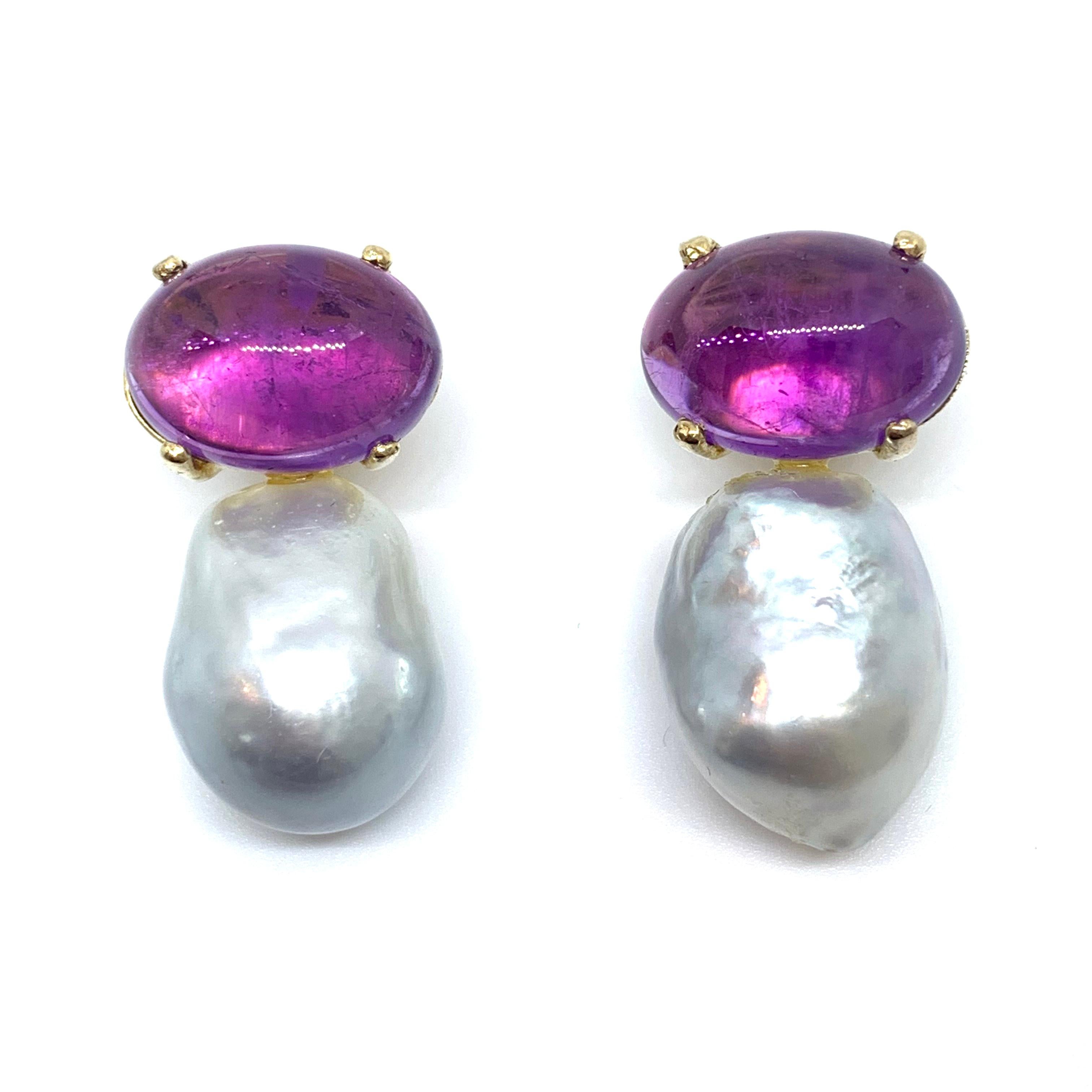 These stunning pair of earrings feature a pair of genuine cabochon-cut oval Brazilian amethyst and lustrous Australian south sea baroque pearls, handset in 18k yellow gold vermeil over sterling silver. The lustrous south sea pearls measure 13mm