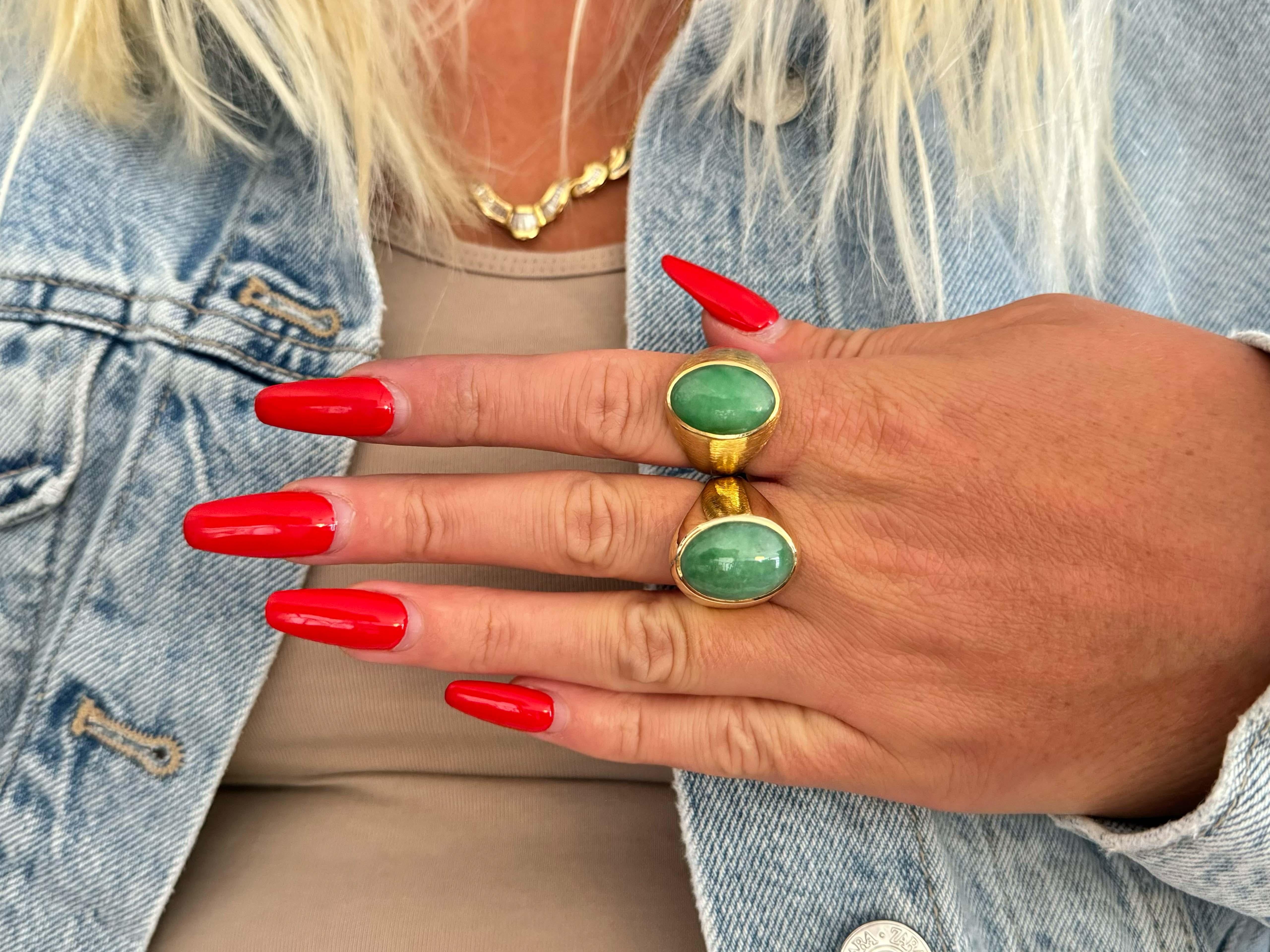 Item Specifications:

Metal: 14k Yellow Gold 

Style: Statement Ring

Ring Size: 8.5 (resizing available for a fee)

Total Weight: 9.8 Grams

Gemstone Specifications:

Center Gemstone: Jadeite Jade

Shape: Oval

Color: Green

Cut: Cabochon 

Jade